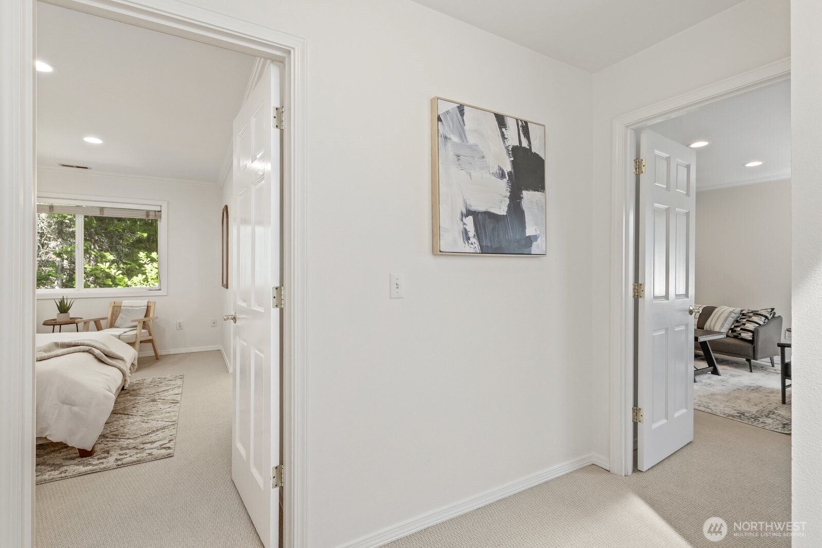 Middle landing with entrance to the primary suite on the left and bonus room and office to the right.