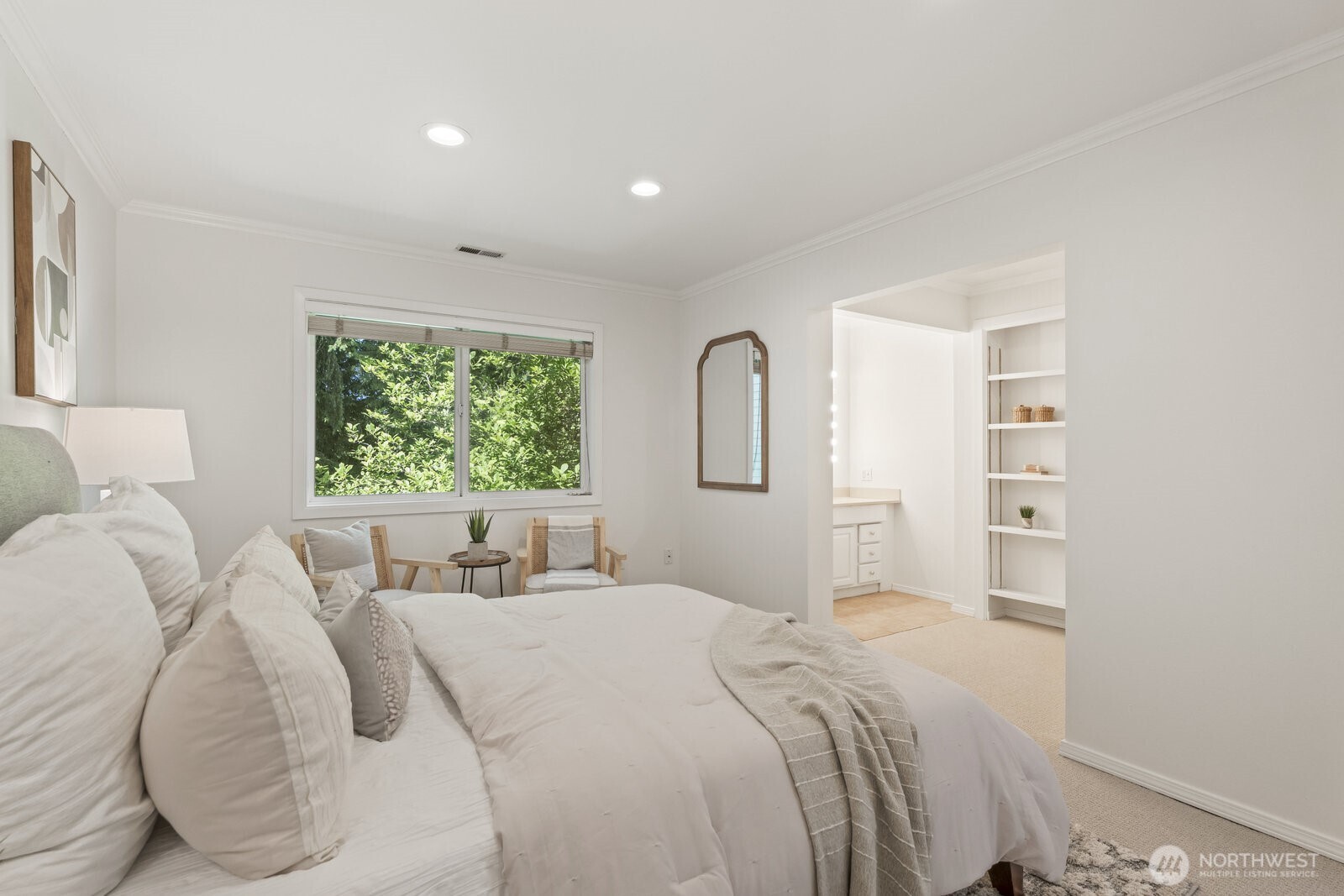 Spacious room with crown molding looking out to quiet the greenbelt.
