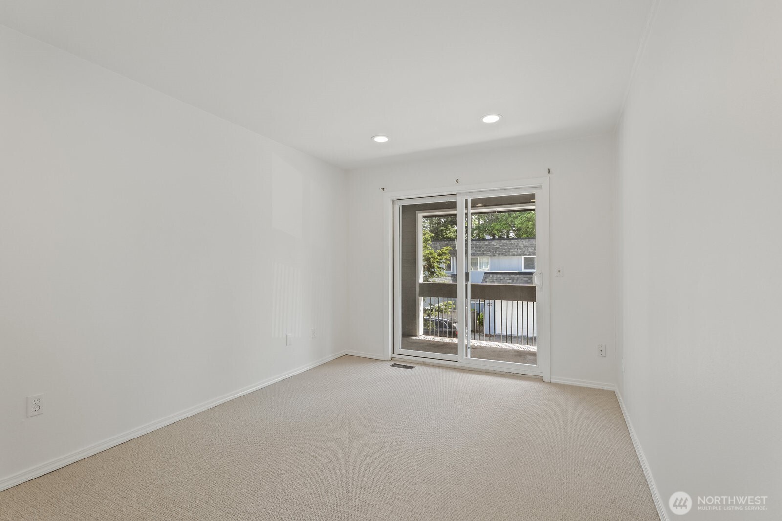 Bedroom 2 with a sliding door to the balcony.