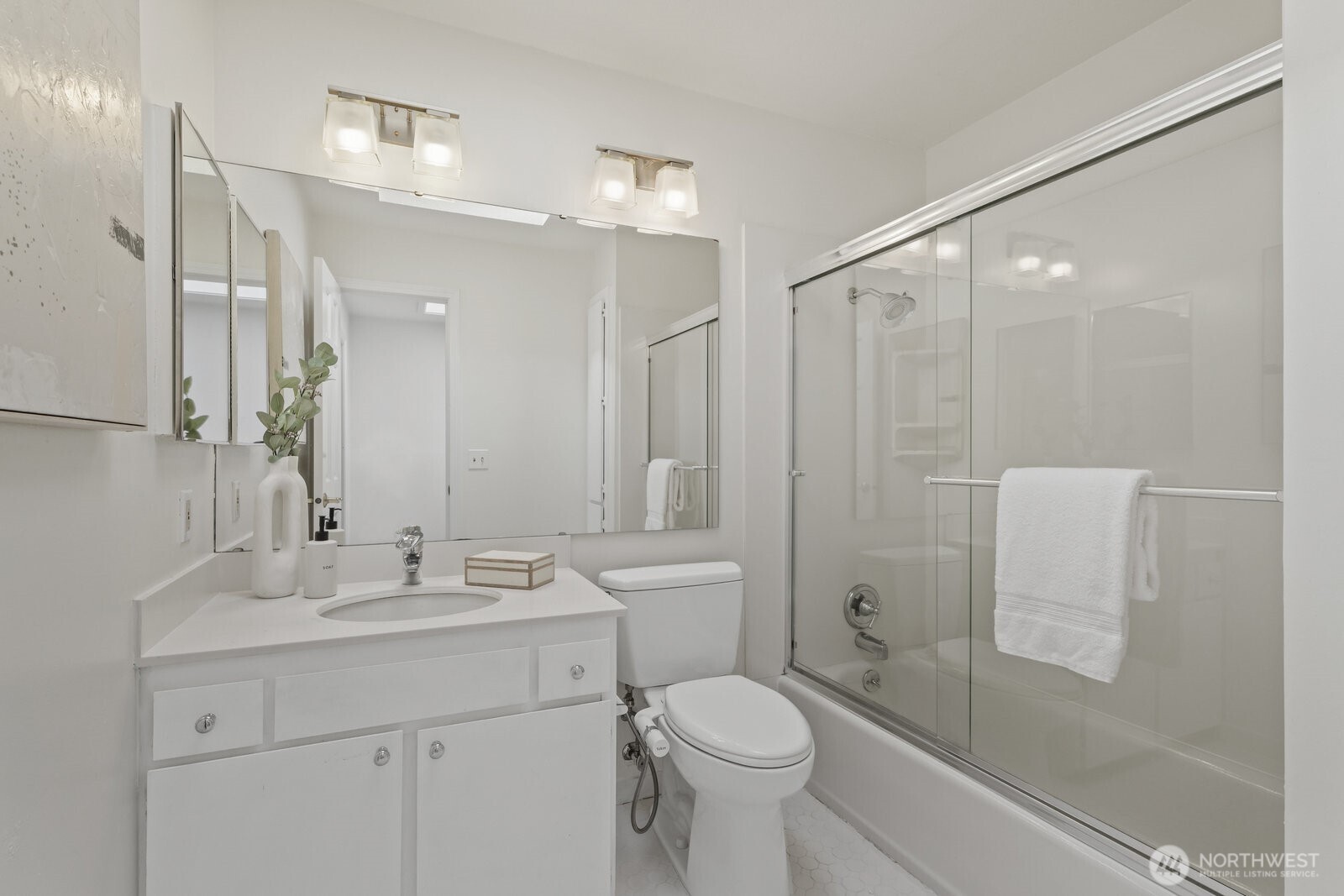 Full hall bathroom with hexagon tile floor.