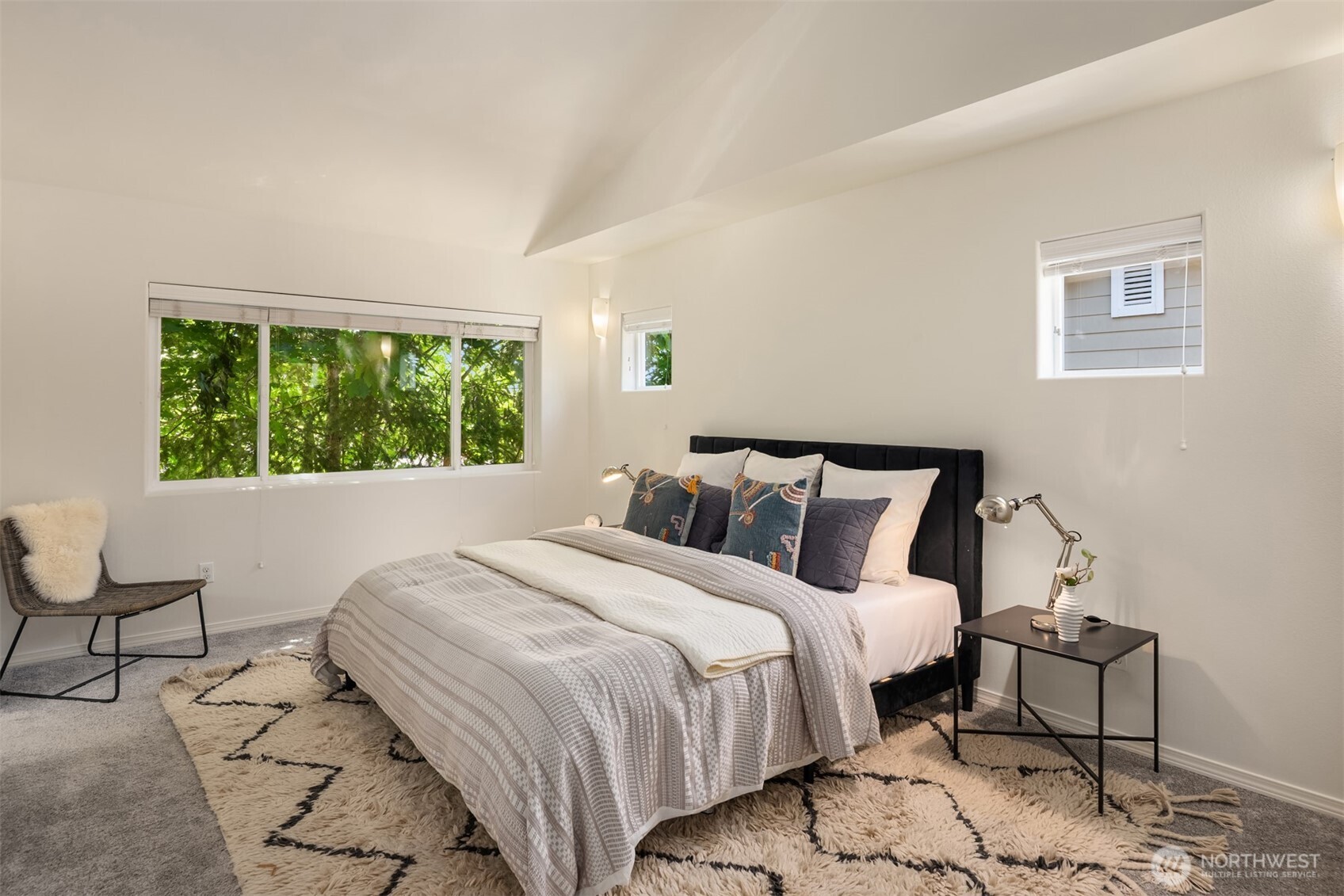 Vaulted primary suite features an evergreen outlook to the south and clerestory windows for light to the west.