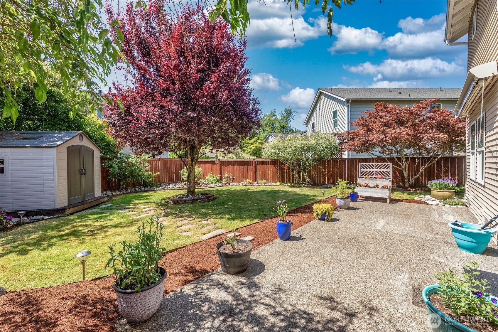 Expanded patio with ample room for seating and barbeque area.
