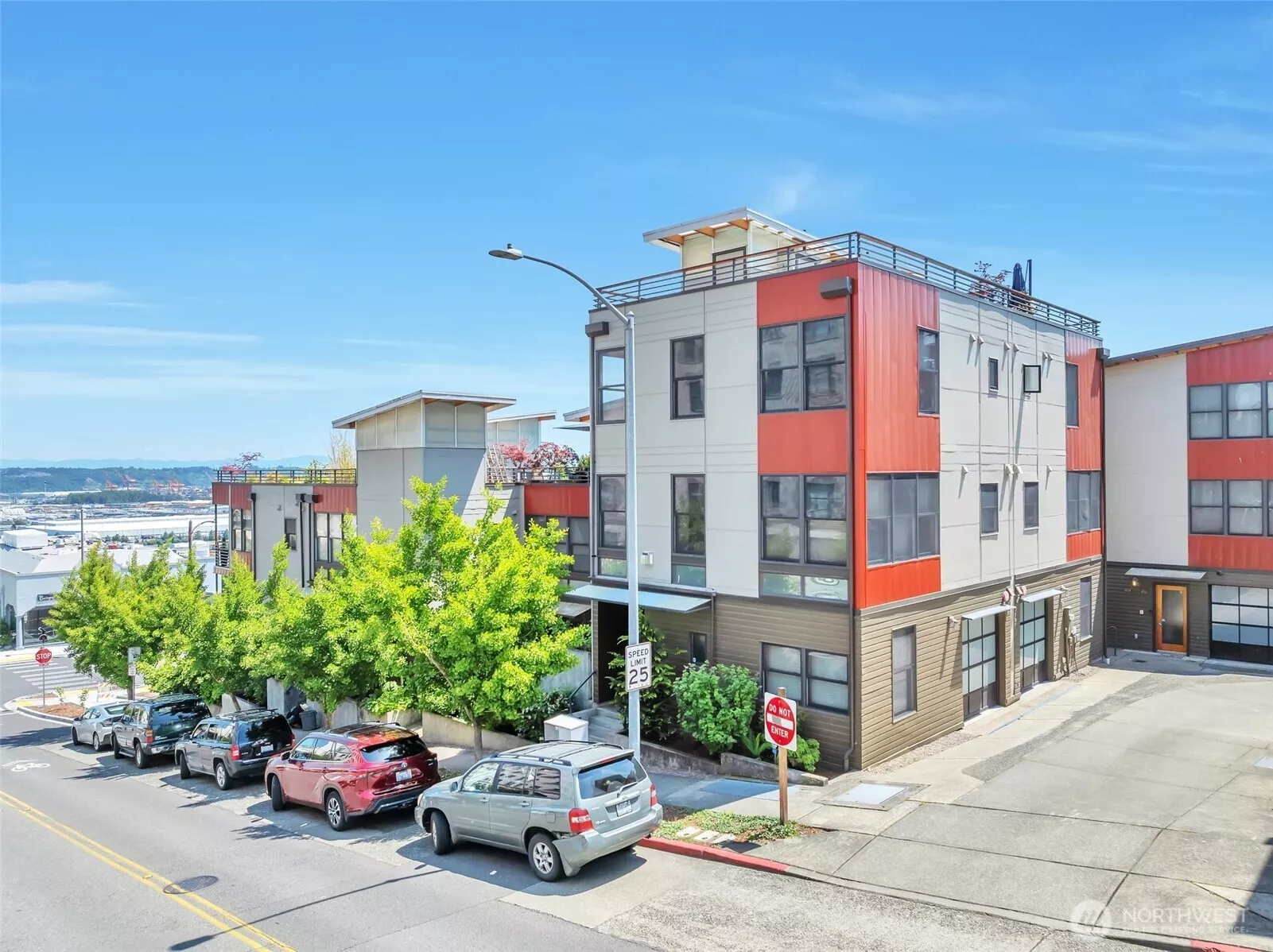 Three story Triangle Townhome with rooftop deck and attached one car garage.