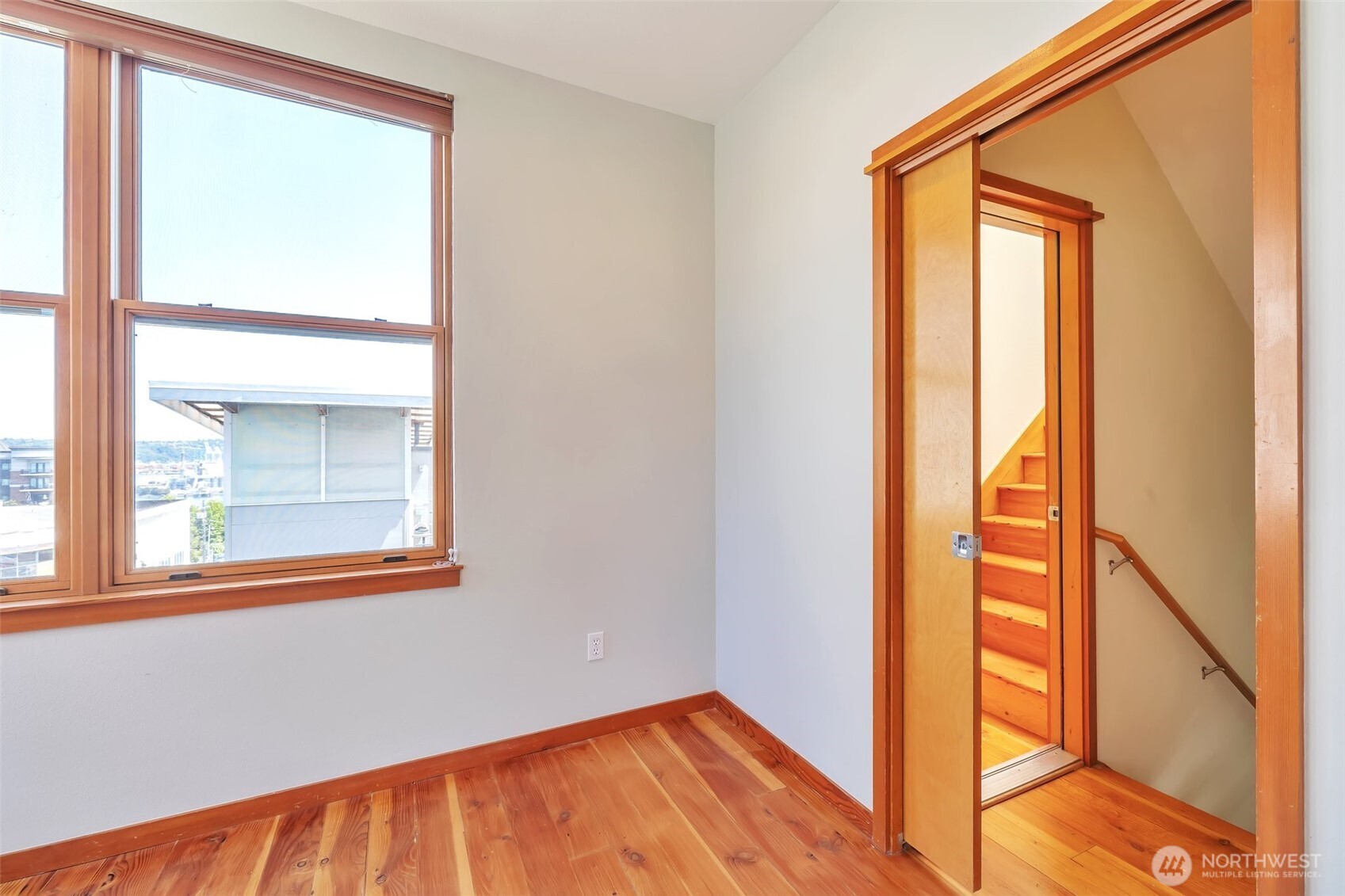The third level has a privacy pocket door separating the bedroom from the open staircase. Access to private staircase to rooftop deck from third floor landing.