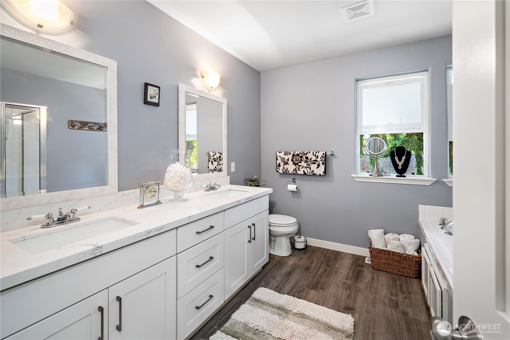 Expansive walk-in closet equipped with built-in cabinetry, complemented by a trendy barn door
