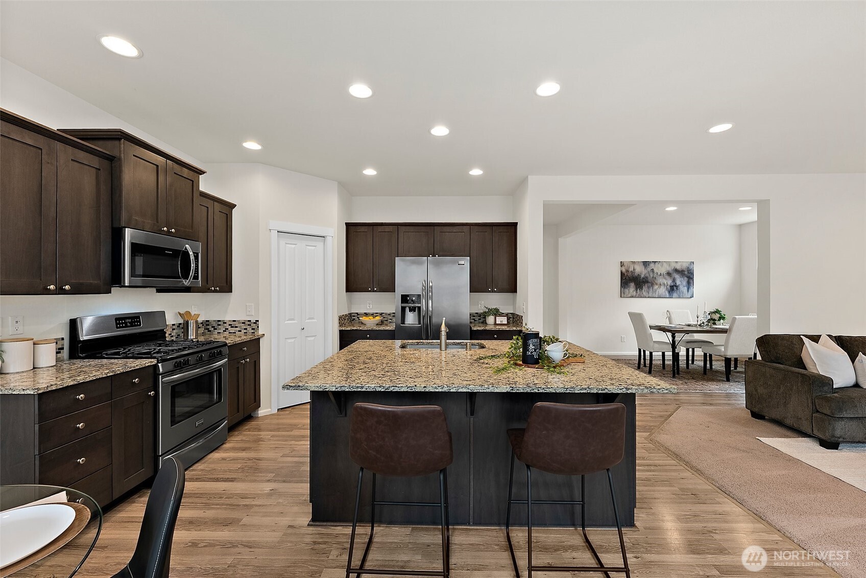 Open Concept Kitchen with stainless gas appliances and granite countertops.