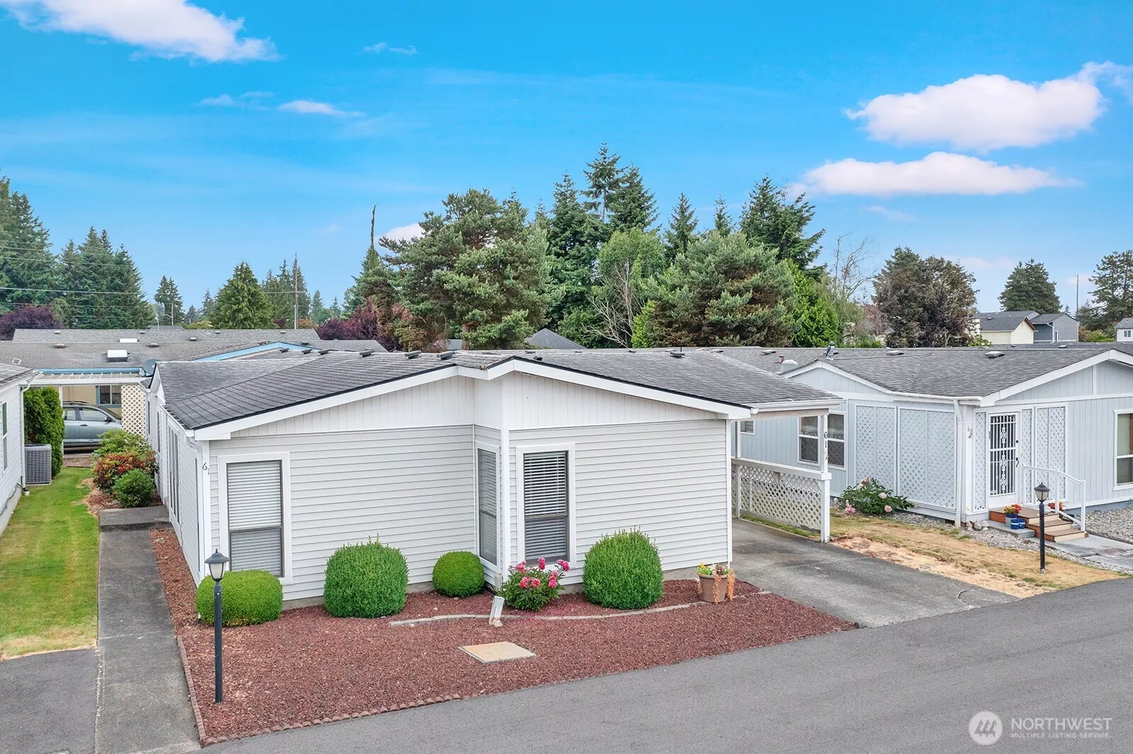 Street view of this one step entry, three-bedroom home in the desirable 55+ Parkwood Land community in North Federal way area. Sidewalk from street to the formal entry of the home.