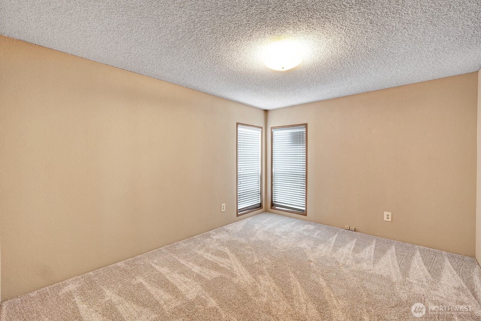 Guest bedroom #2 at the southwest end of the home. Floor to ceiling widows bring in ample natural light. Custom plantation blinds for privacy.