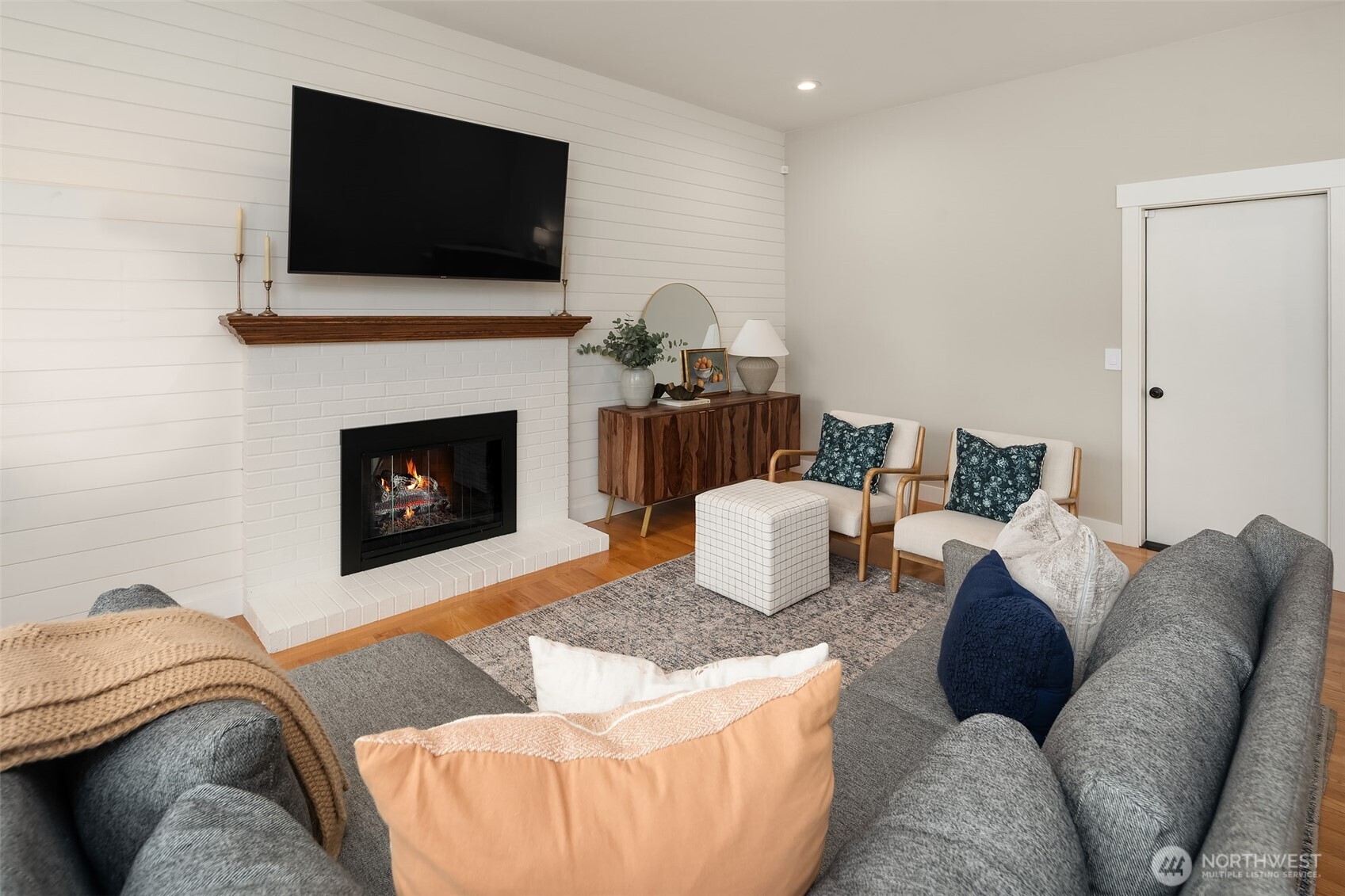 Shiplap wall adds the perfect touch to this cozy family room.