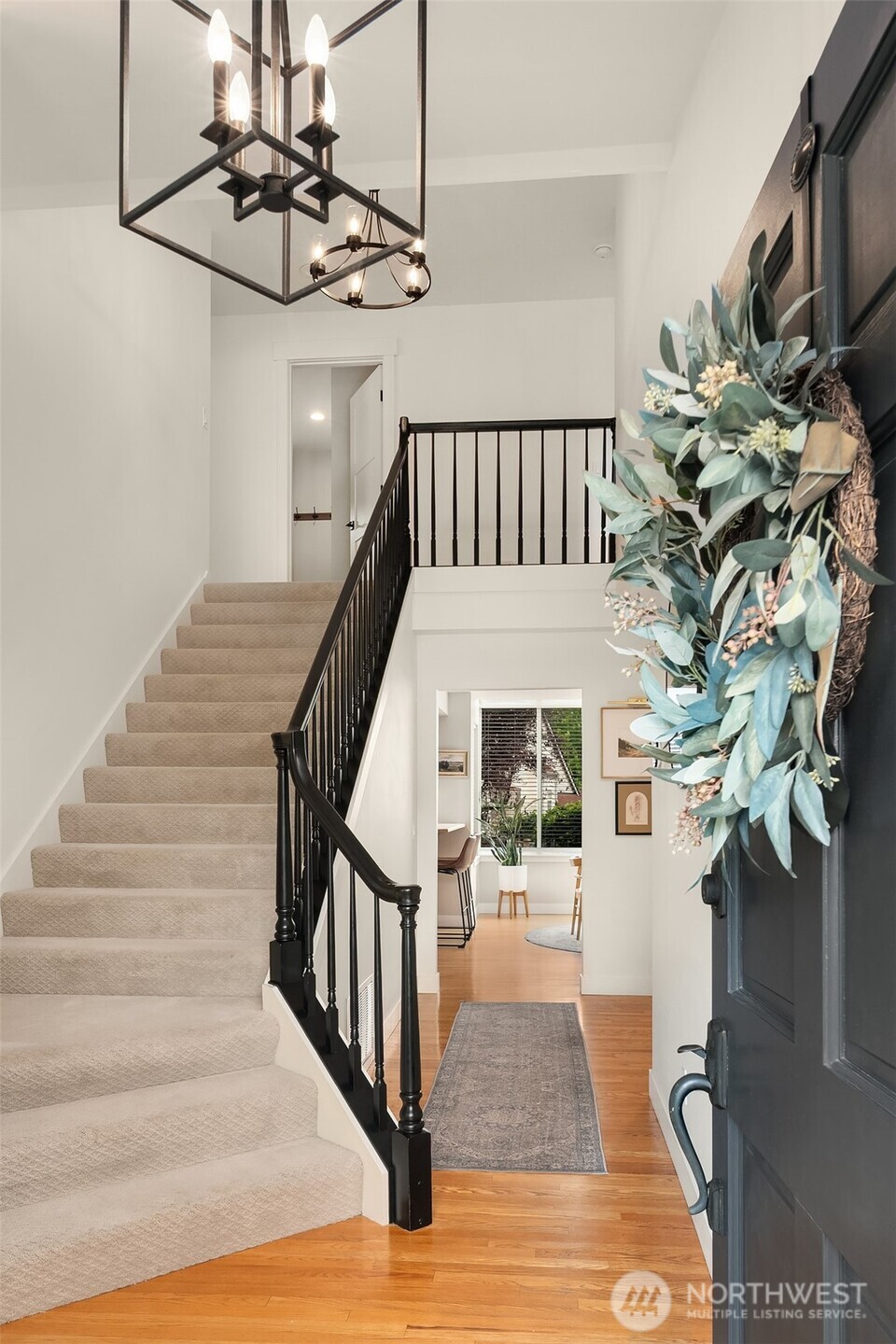 Inviting hardwoods, open rail banister and vaulted ceilings adorn the entry.