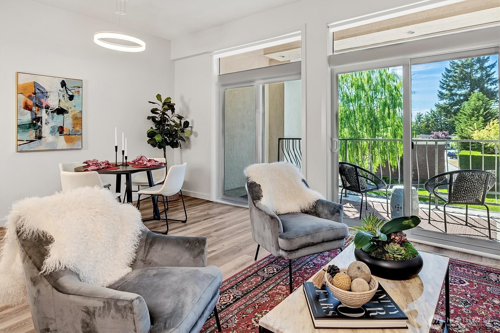 Two sets of sliding glass doors with clerestory windows expand the living space, inviting in natural light and the lush greenery outdoors.
