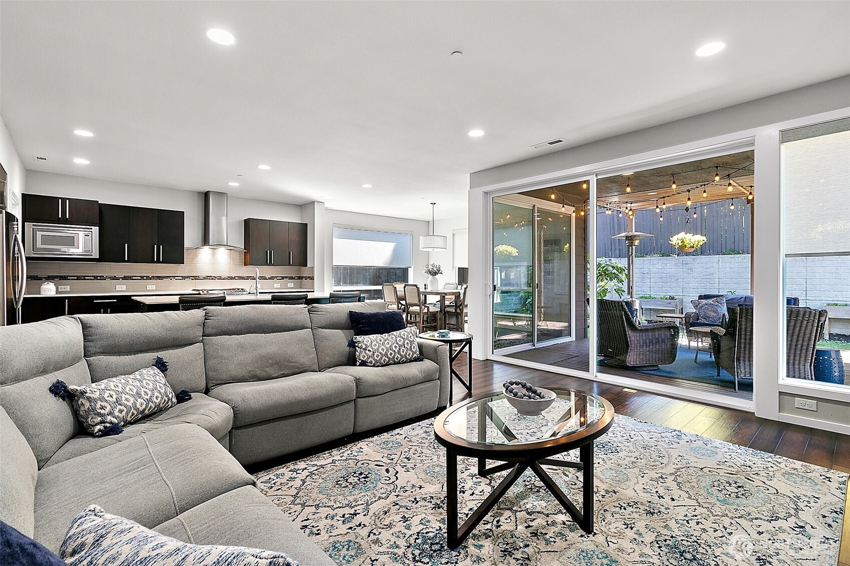 Double sliding glass doors open to create a huge indoor / outoor space.