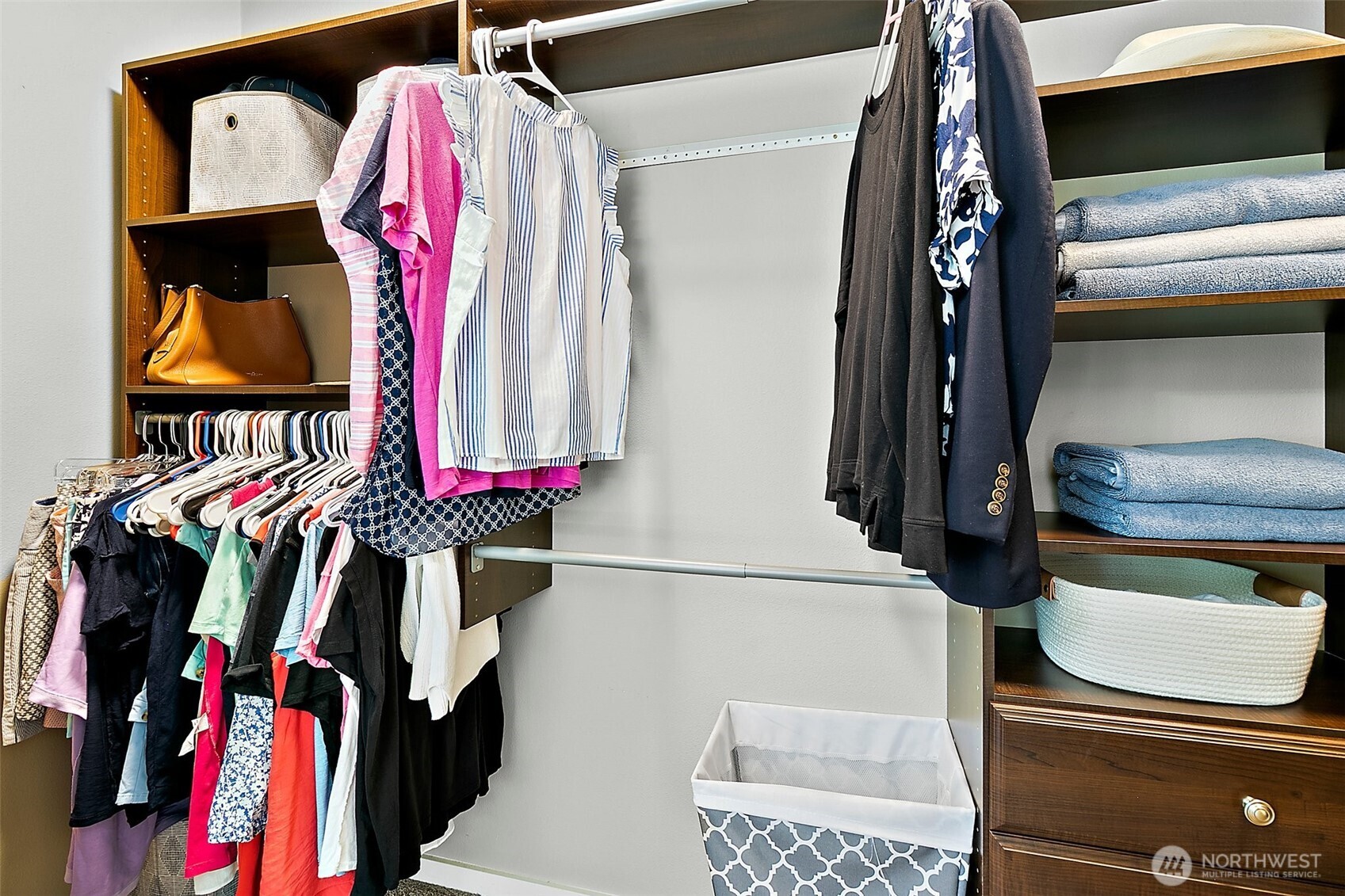 Large walk-in closet with built in organizer.