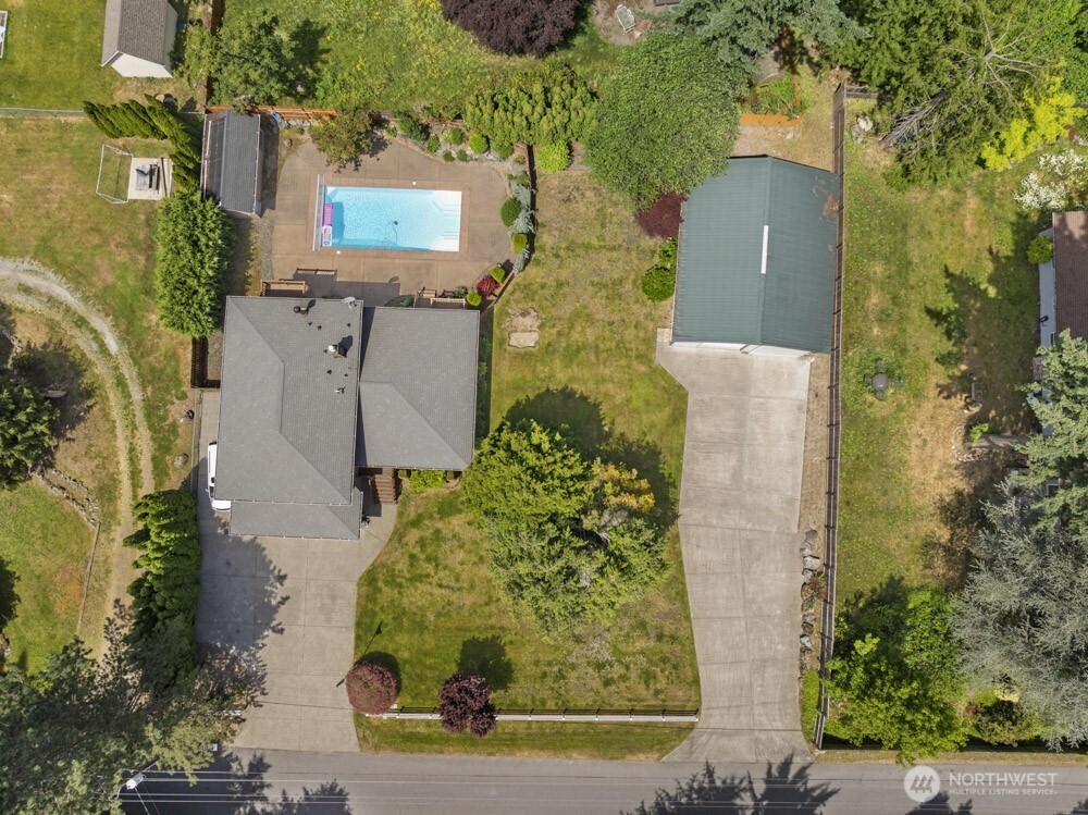 Saltwater in-ground pool, detached shop, tons of parking and privacy!