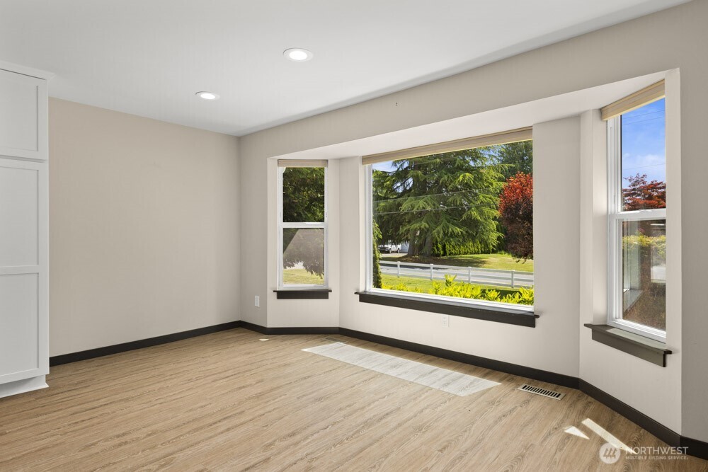 The bay windows beautifully frame the dining space, adding charm and natural light.