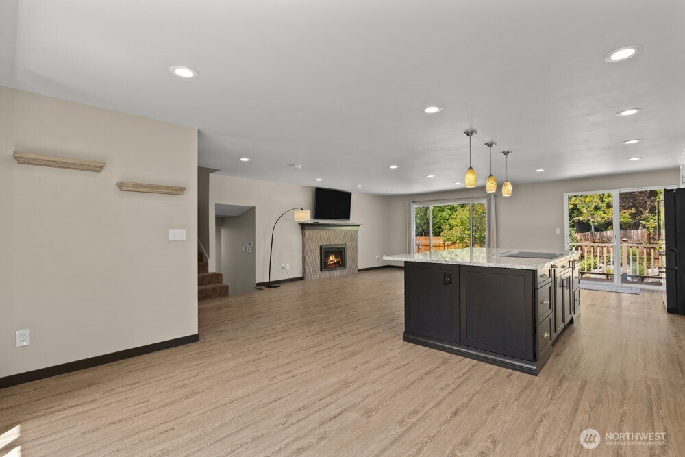 The heart of the home is this spacious great room—where the kitchen, dining, and living areas come together in one seamless space.