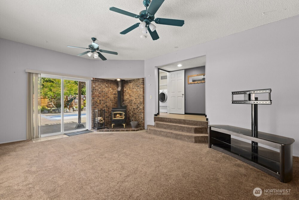 Step out from the cozy rec room onto the patio that leads to your own inground saltwater pool—summer fun starts here!