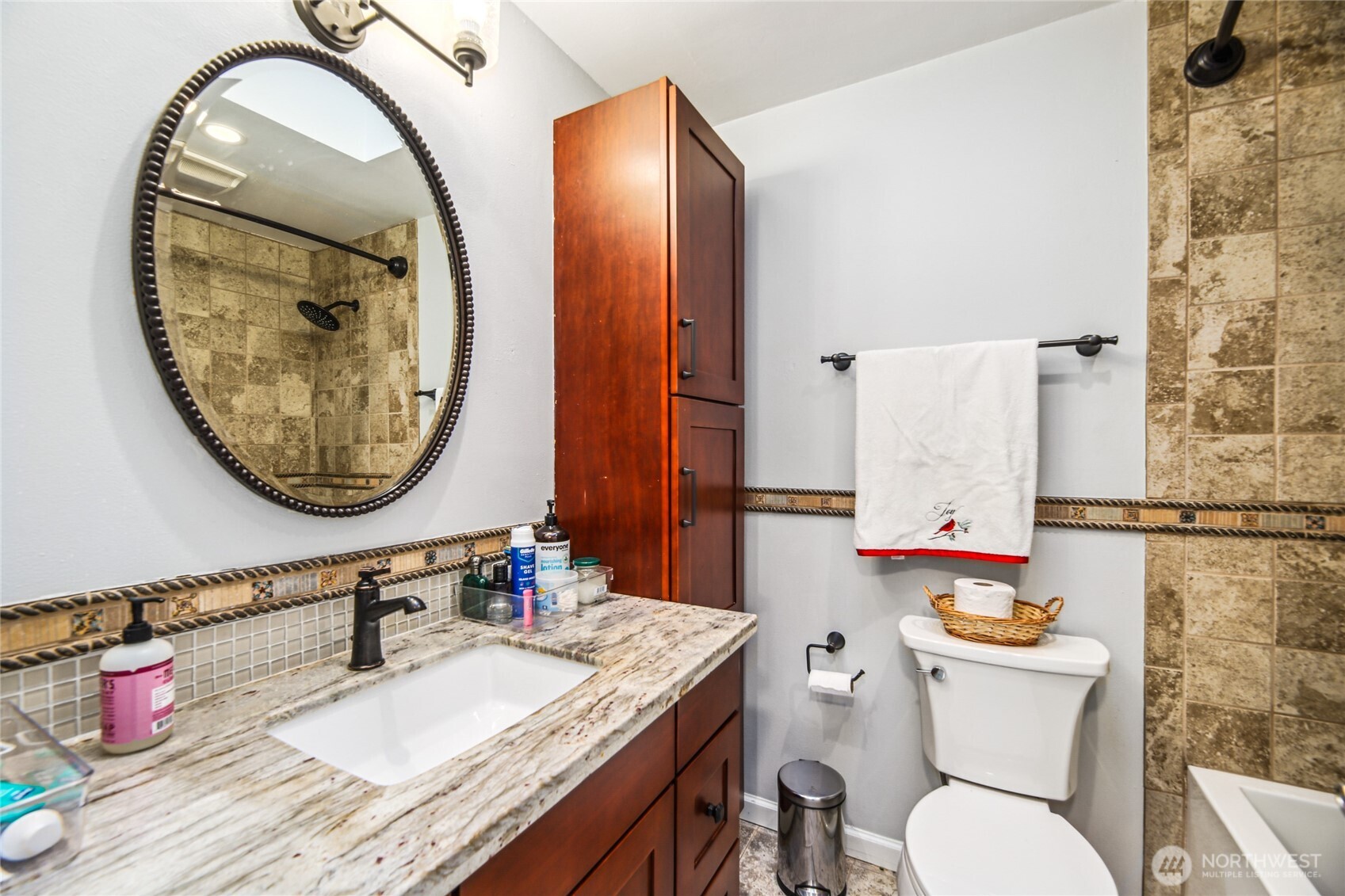 Full guest bathroom located on upper with new paint and warm, neutral tone finishes.