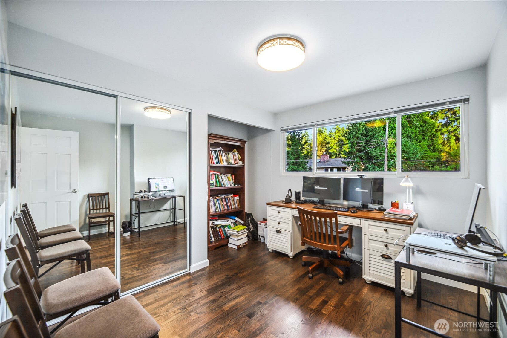 Tons of storage and natural light burst through one of four upper floor bedrooms.