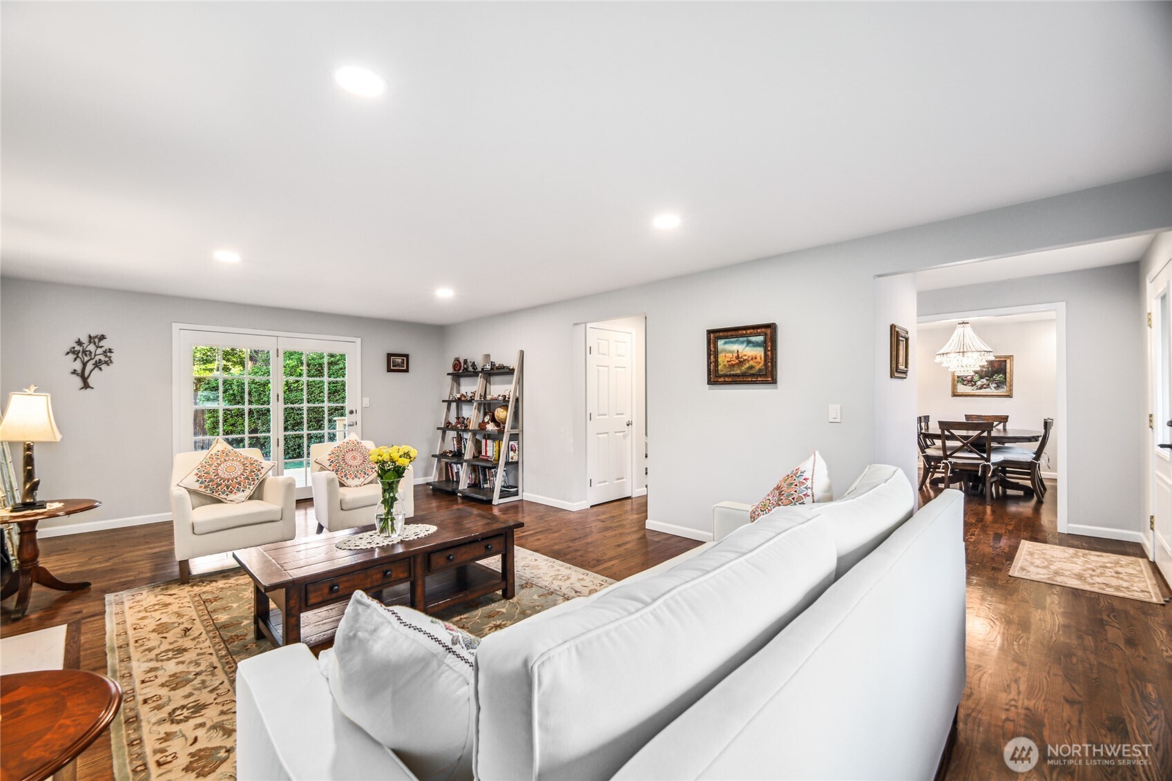 Comfortable living room with designer paint colors and French doors leading to sweeping covered deck and quiet backyard.