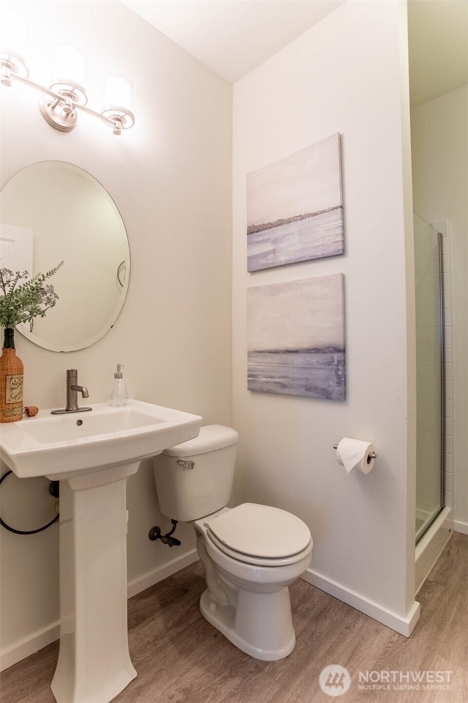Three Quarter Bath on Main Floor with all NEW VINYL PLANK FLOORING. Great to have a Shower Stall in the Main Floor Bath for the Guest Bedroom.