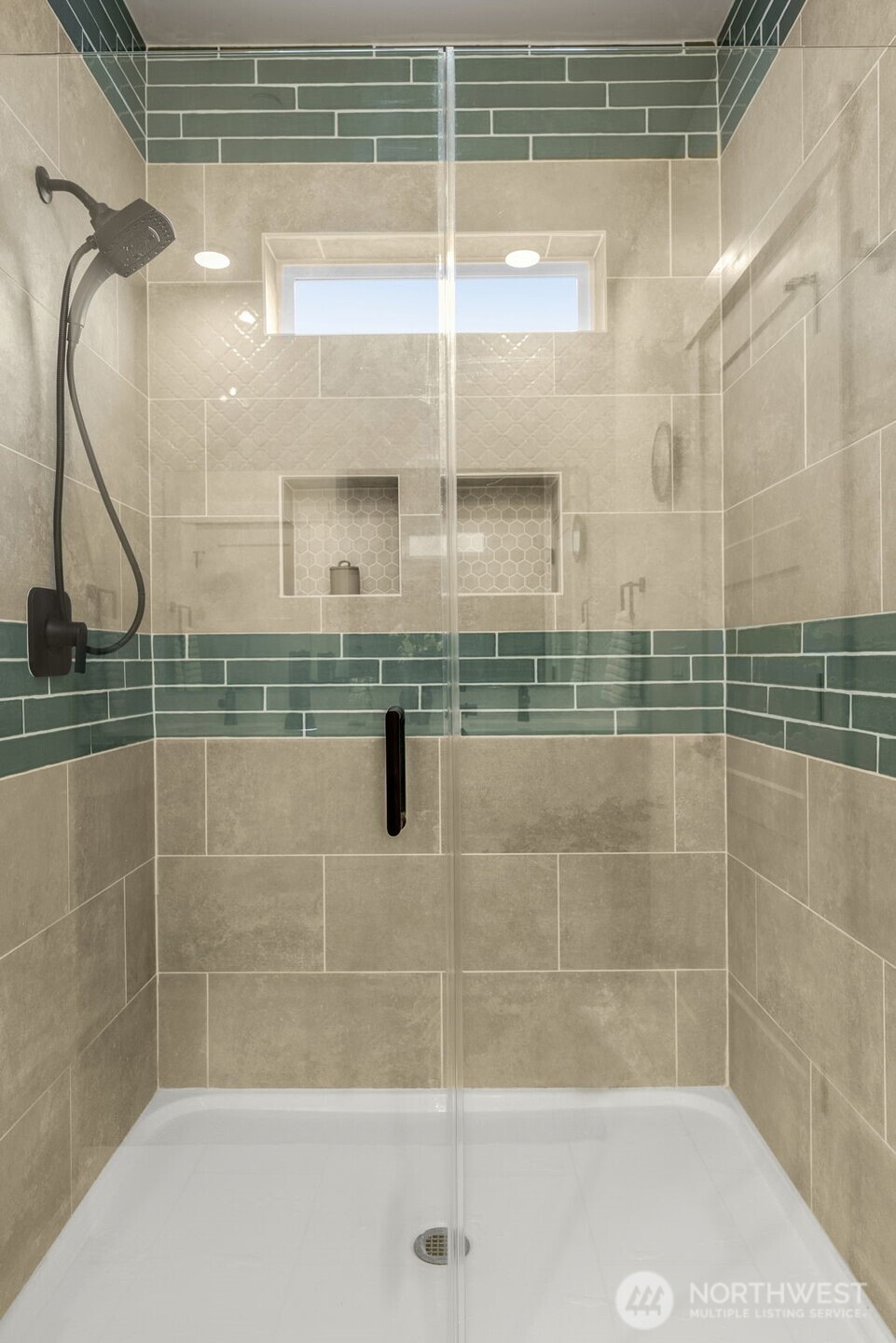 Spacious walk-in shower w/ glass door.