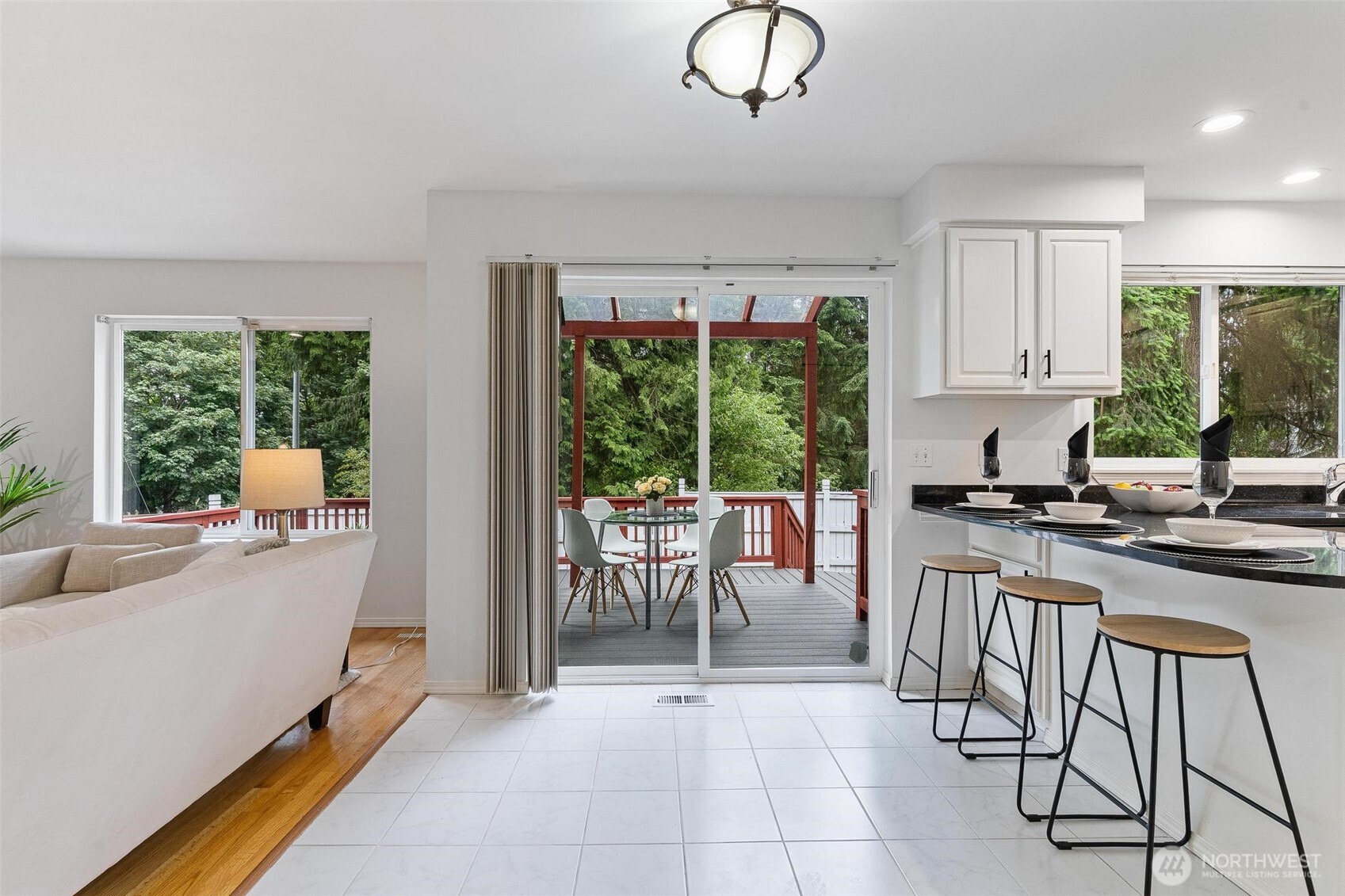 Slider off the kitchen opens to the expansive deck for seamless indoor-outdoor living.