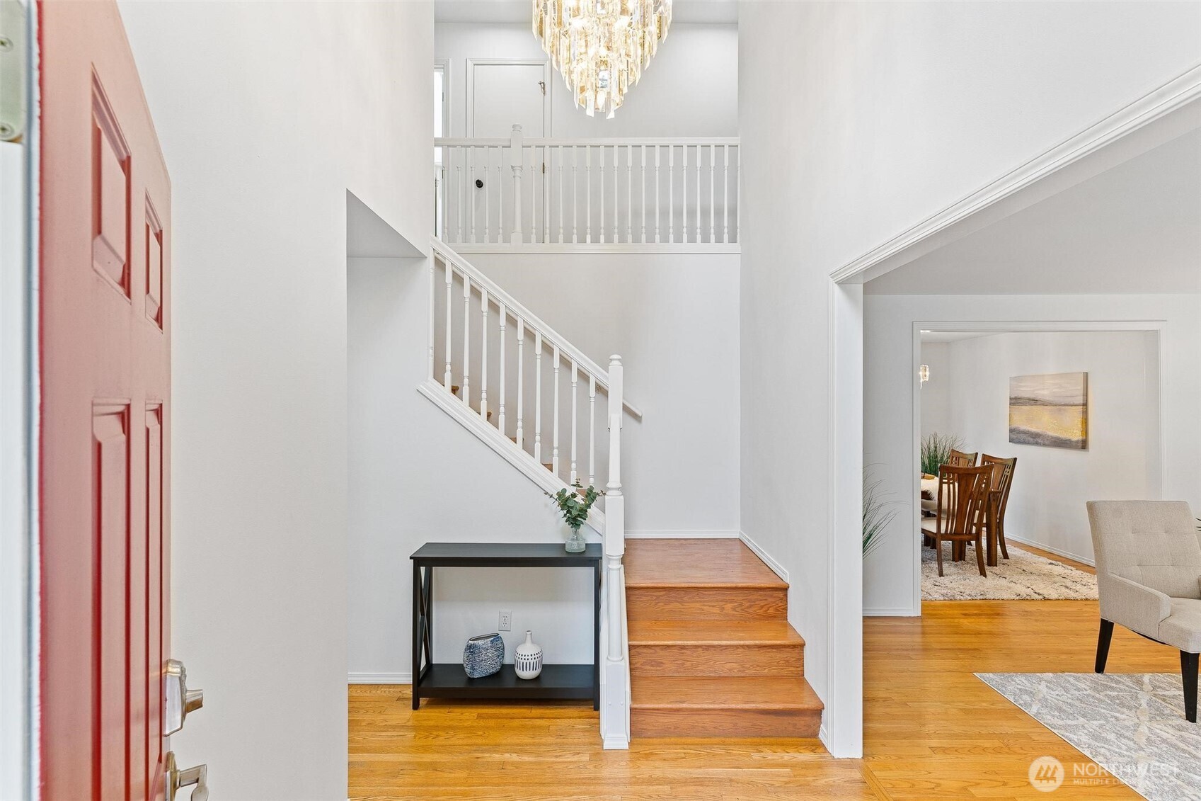 Entry with soaring ceiling and hardwood floors that flow throughout the main living areas.