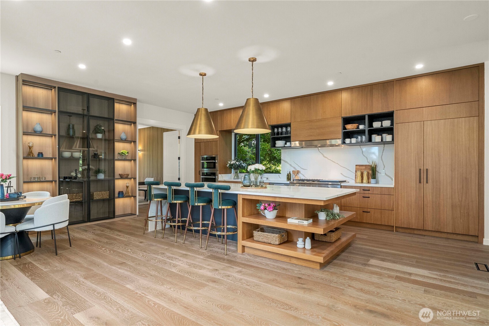 The chef’s kitchen is a culinary masterpiece, featuring a massive center island ideal for entertaining, meal prep, or casual gatherings—blending style and function effortlessly.