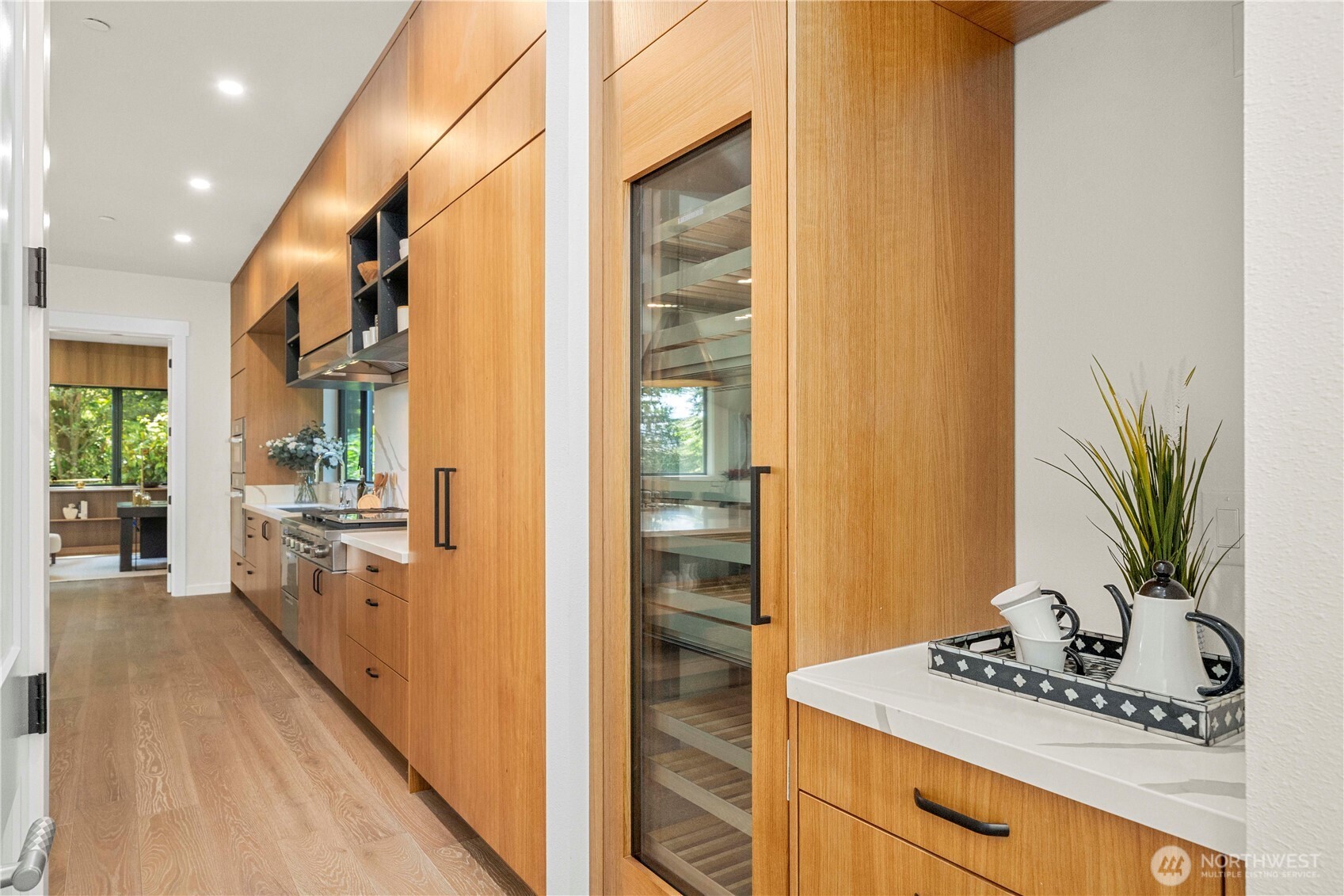 Equipped with a sleek wine cooler, ideal for effortless wine storage and easy access during gatherings.