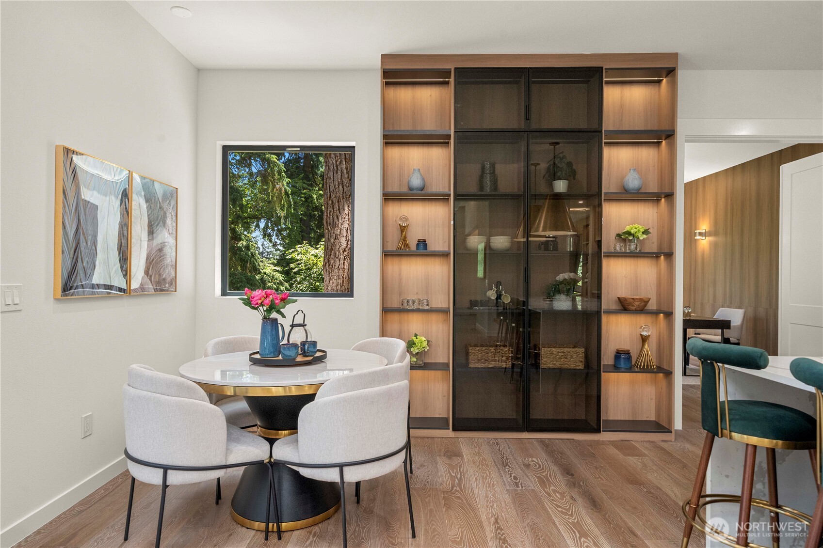 The cozy breakfast nook offers direct access to a charming private deck, perfect for morning coffee or casual meals.