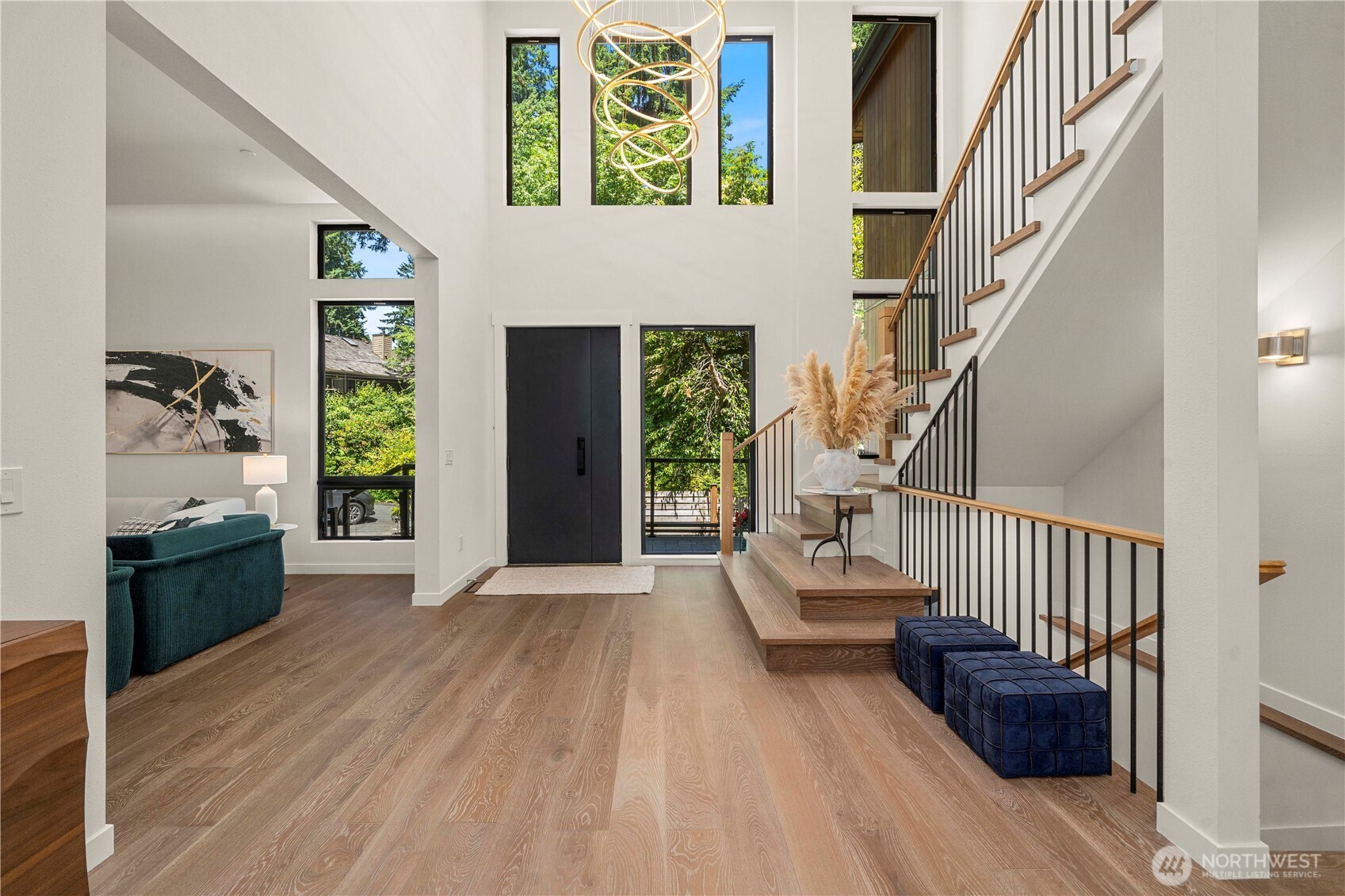 Enter through a dramatic foyer illuminated by exquisite designer lighting, creating an unforgettable first impression with its soaring ceilings and timeless elegance.