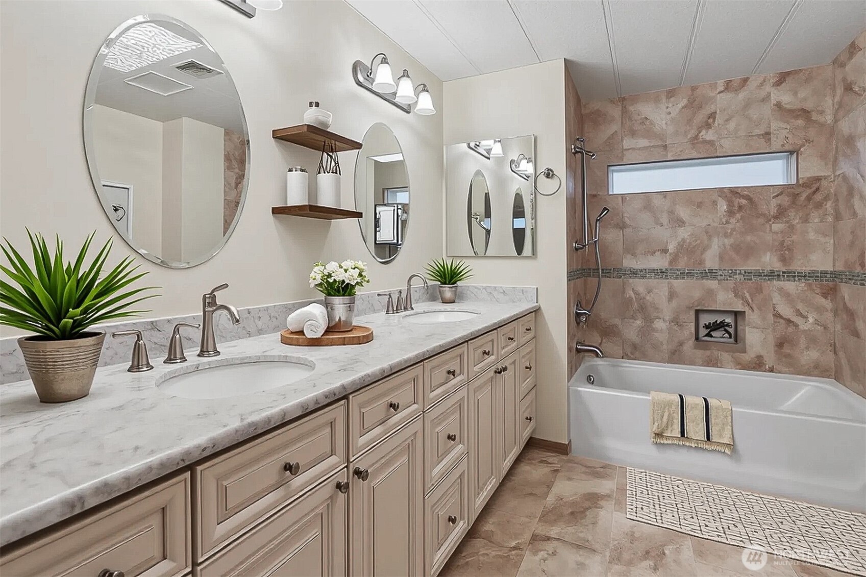 Primary bedroom suite with vaulted ceilings, walk in closet and a fully remodeled tiled 5 piece bathroom. - Virtually staged photo.