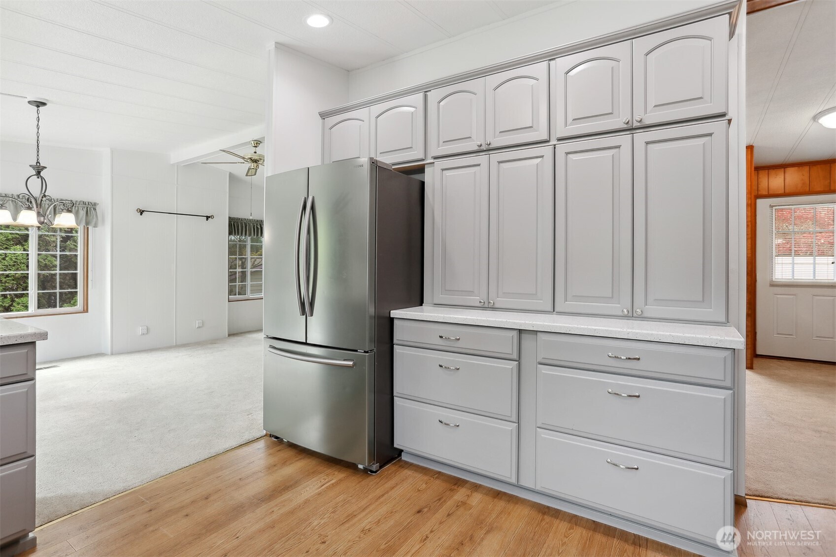 Fully remodeled gourmet kitchen with quartz counters, stainless appliances and a breakfast bar that opens to the dining area and family room with a sliding door to the back patio for indoor/outdoor living.