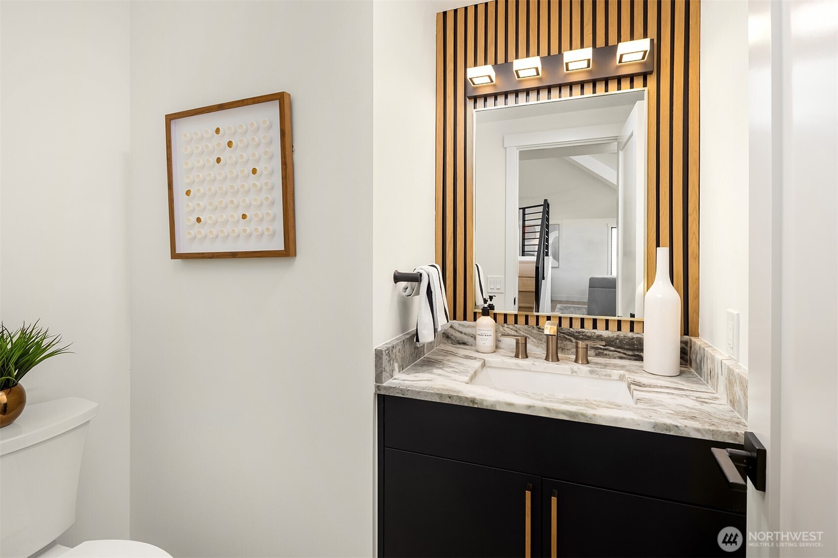 Striking powder room features textured granite top and custom millwork.
