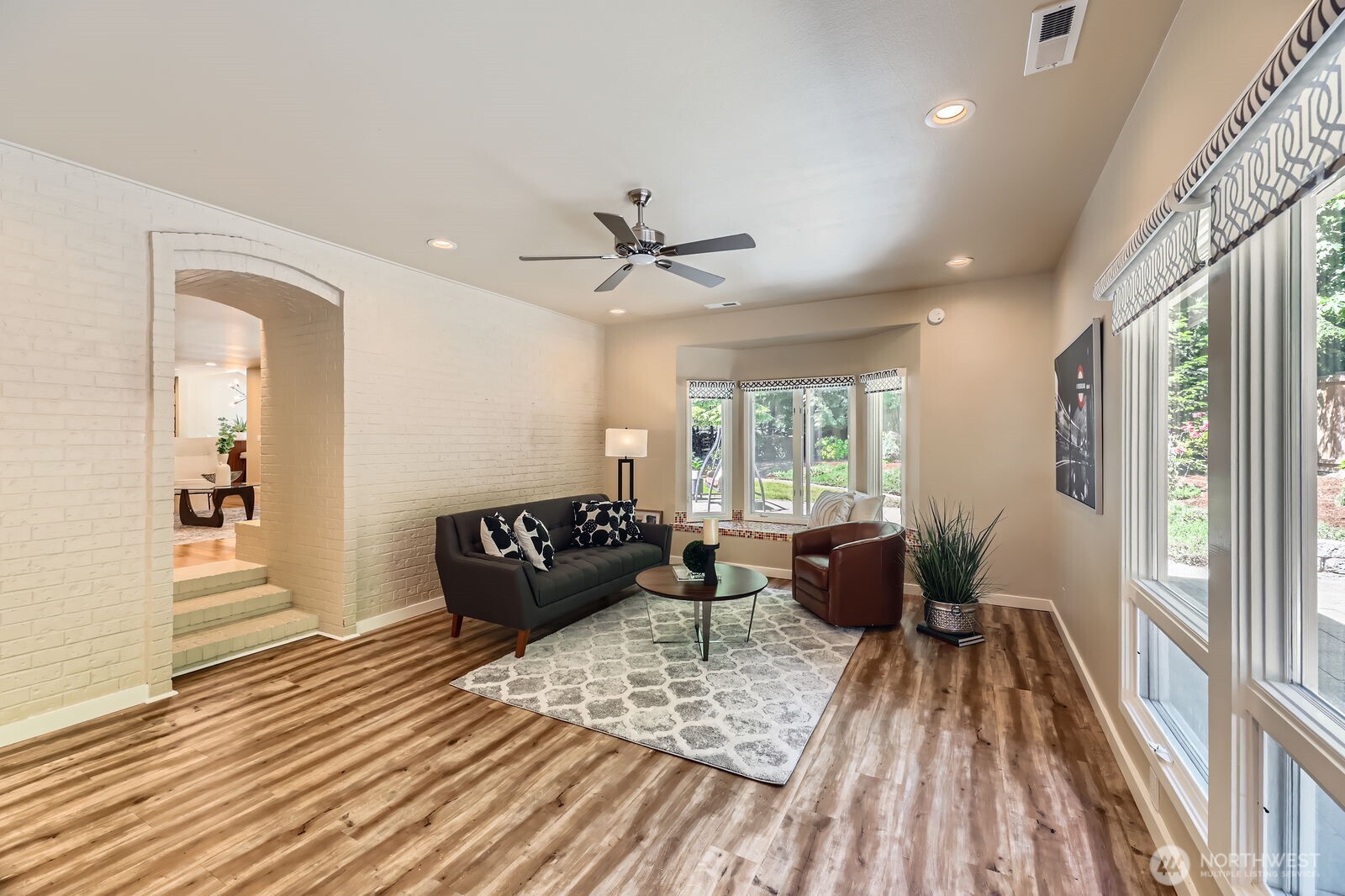 The bonus room off the family room features a bay window with seating.