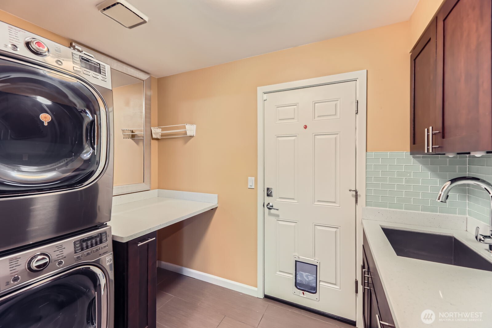 Laundry room with built-ins and a convenient sink.