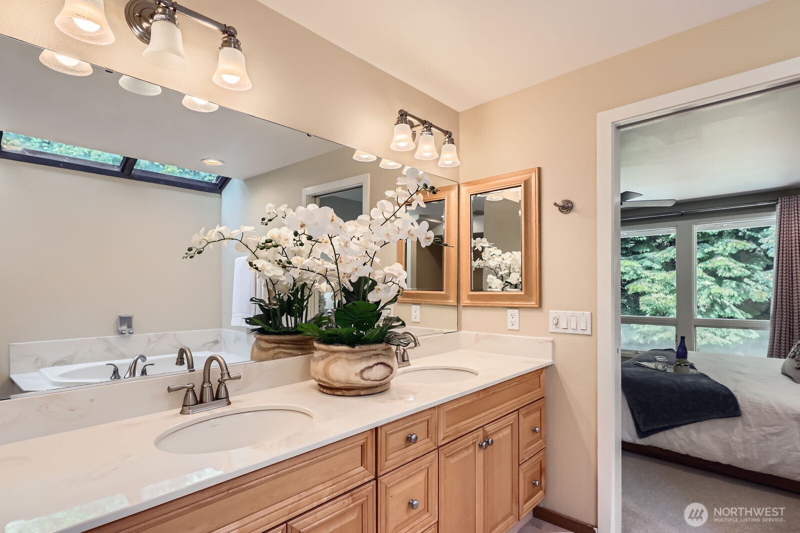 The spa-inspired primary bath features a dual sink vanity, soaking tub, separate shower, and walk-in closet.