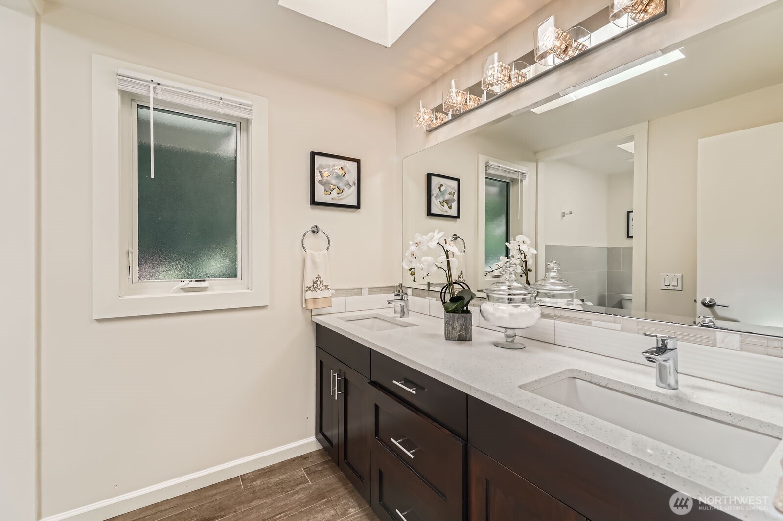 Full bath upstairs hallway with dual sink vanity.