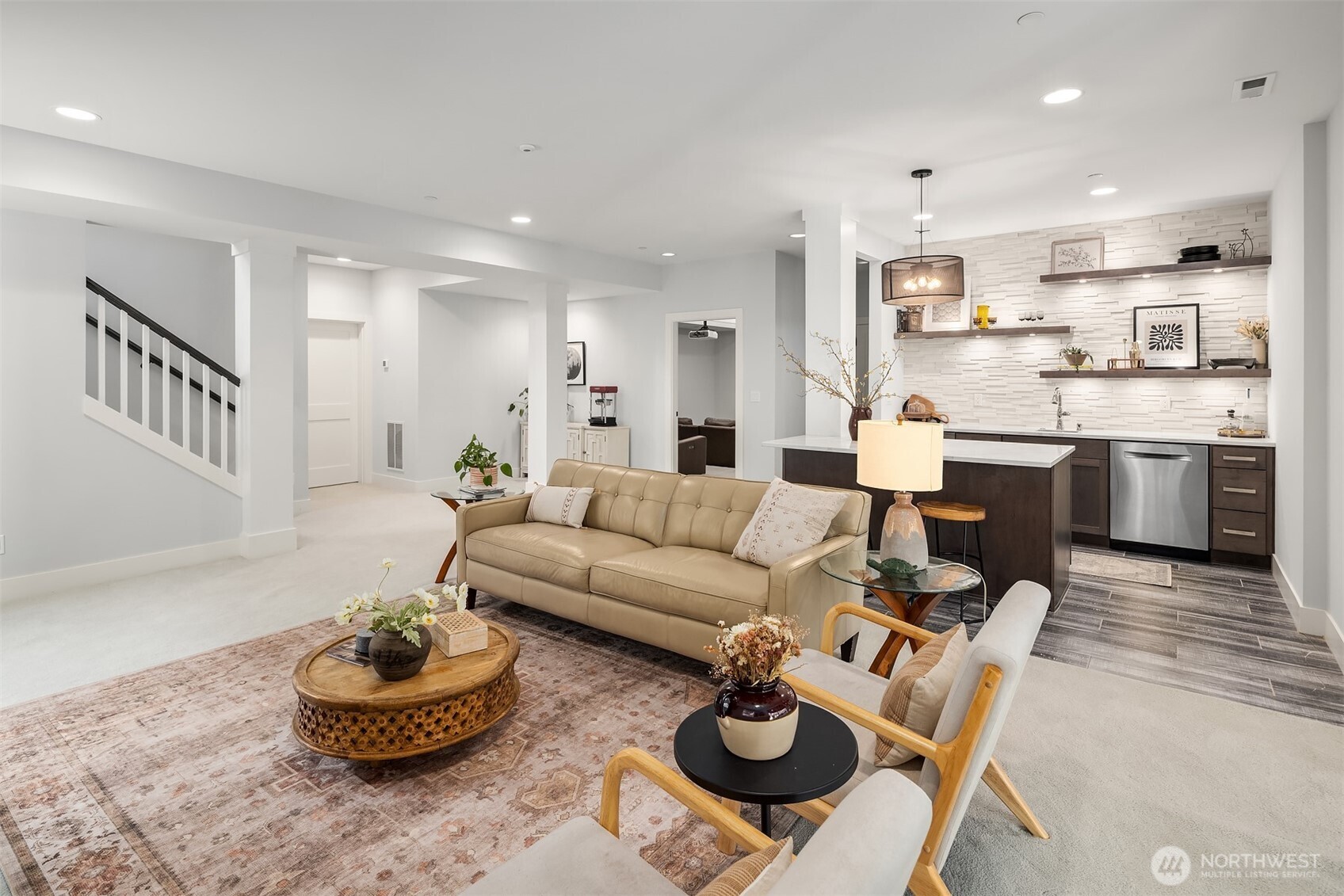 The lower level elevates everyday living with entertainment spaces par excellence—featuring a fully equipped bistro kitchen, expansive flex space, dedicated theater room, and two additional bedrooms. This thoughtfully designed level creates endless possibilities for hosting, multi-generational living, or work-from-home arrangements.