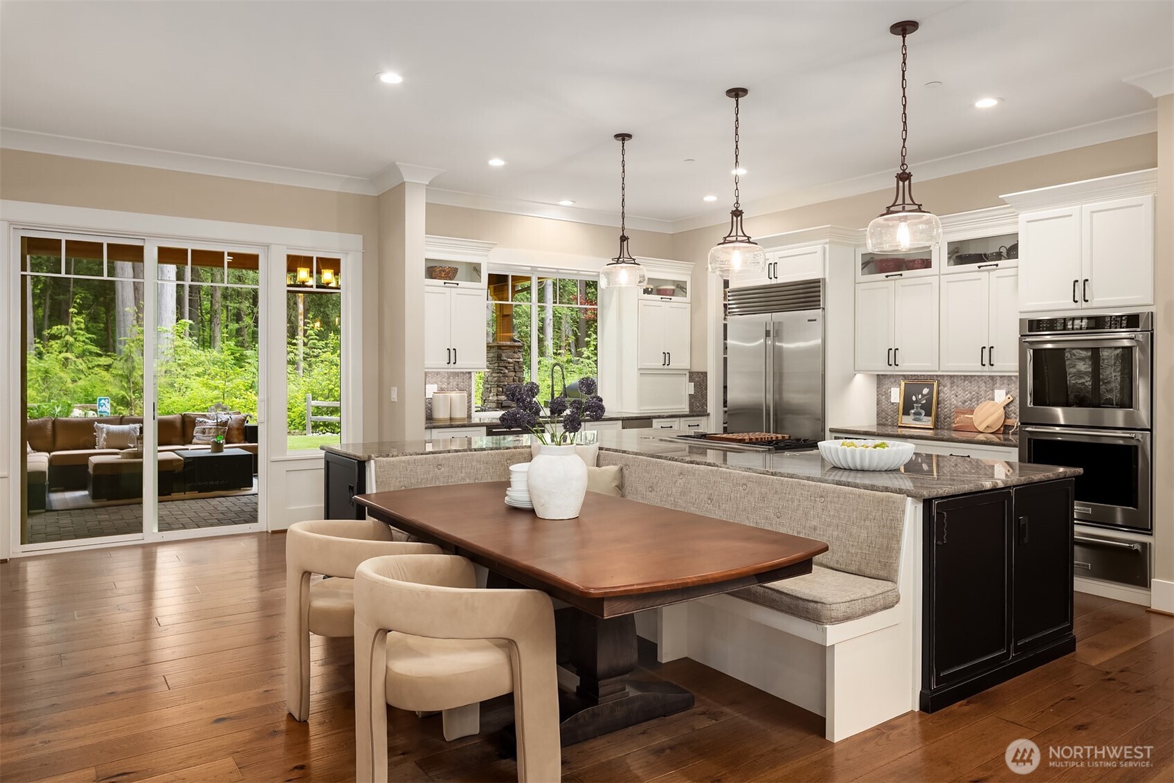 Chef's kitchen is the heart of the home with high end appliances, built in banquette seating and 2 large pantries. Opens up to covered outdoor entertaining area