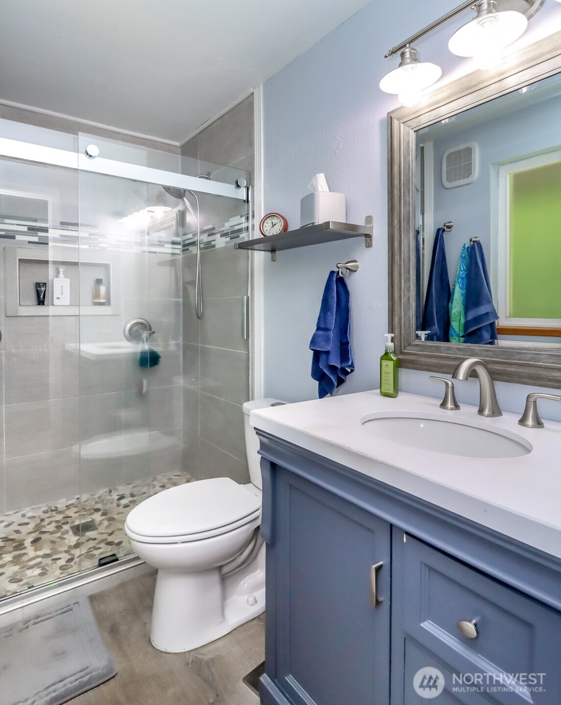 Primary bathroom with a large tile shower, complete with DUAL SHOWER HEADS.