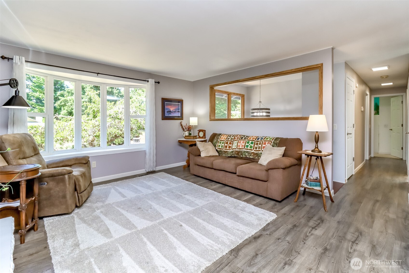 The upstairs living room is brite and open with the bay window.
