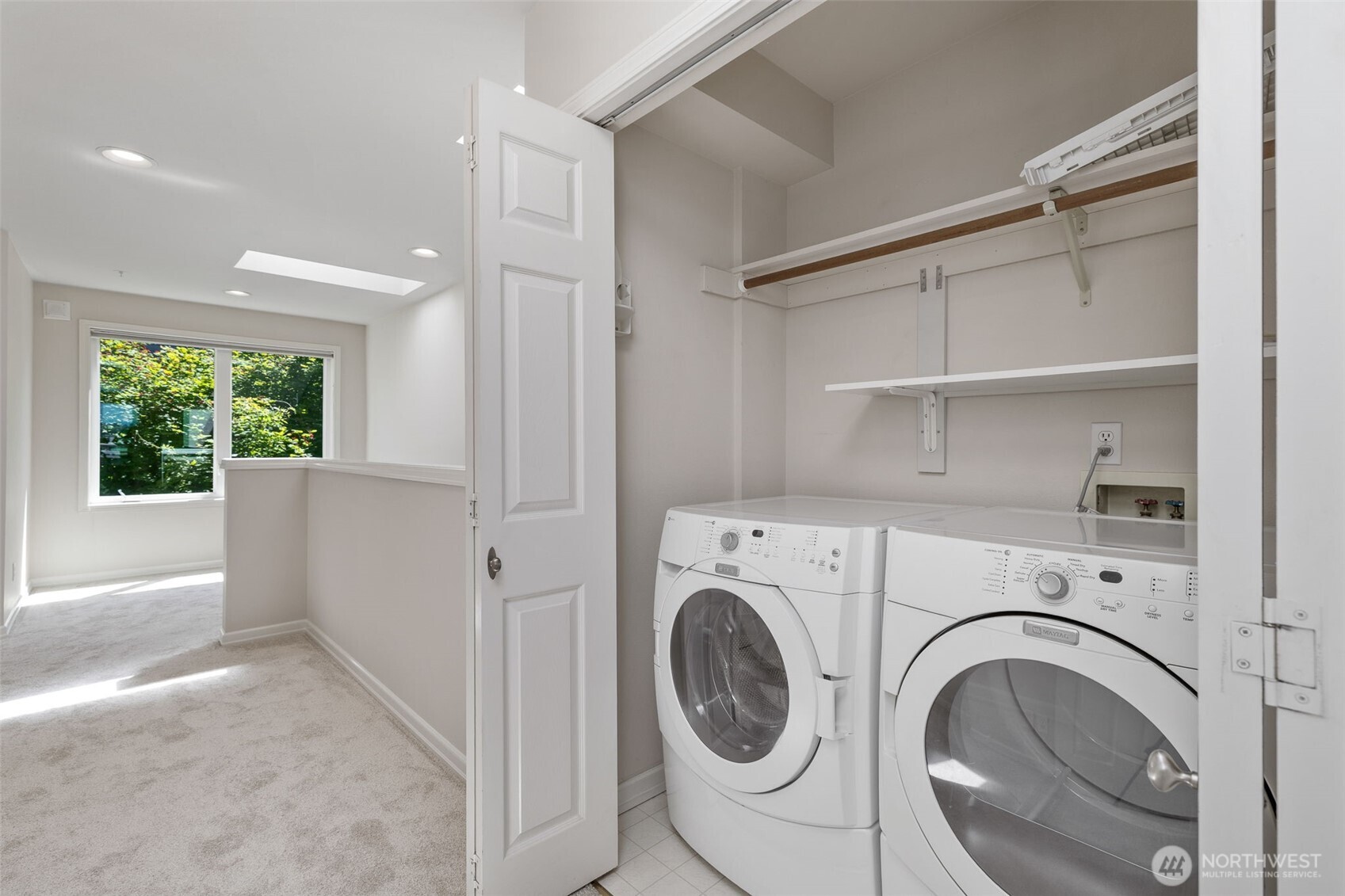Laundry area on upper floor with Office space next to windows.