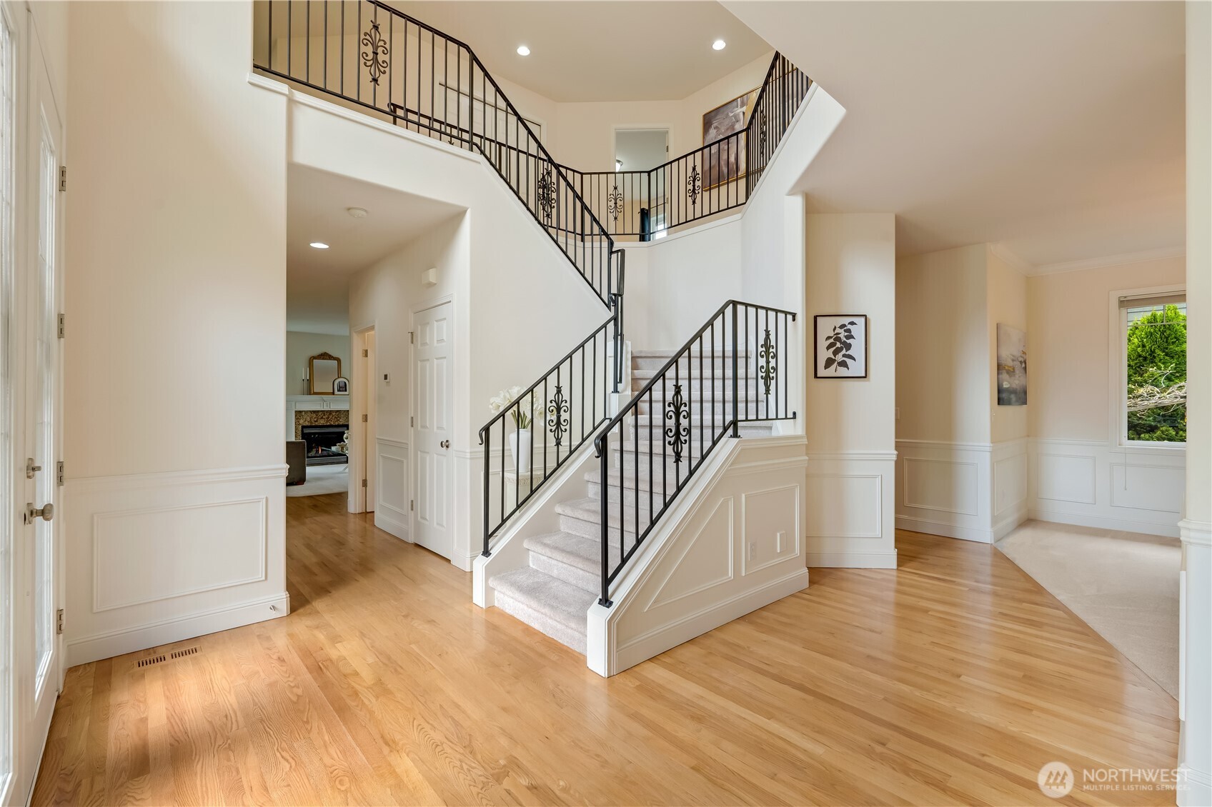 grand entrance with hardwood floors and extensive mill work