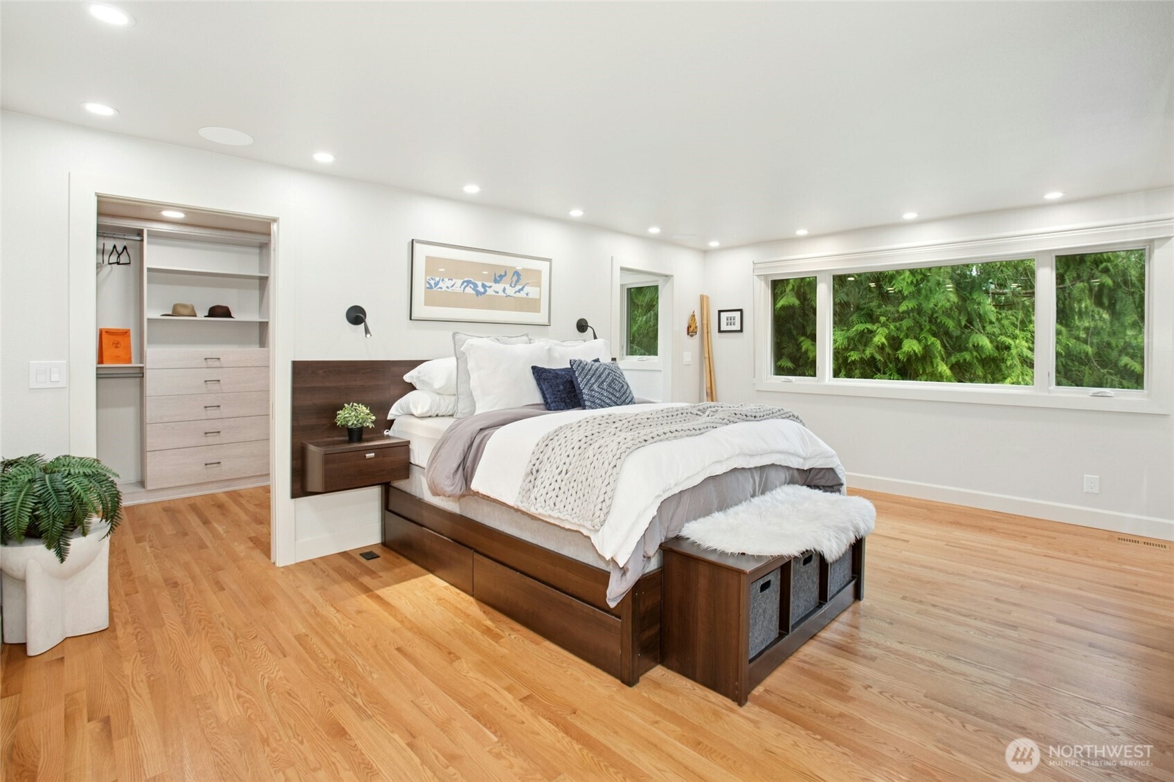 California Closet system to the left and a private office to the right of the bed.