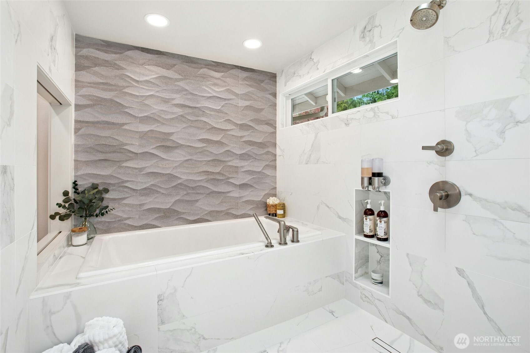 Incredible large walk in shower with Porcelanosa tiles, skylight overhead, with 2 shower heads-handheld and overhead and wet area with cast iron tub.