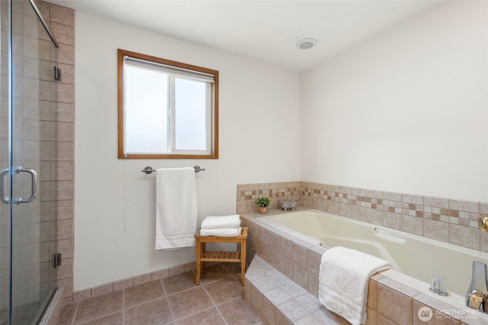 Tile floors, shower surround and soaking tub in primary bath.
