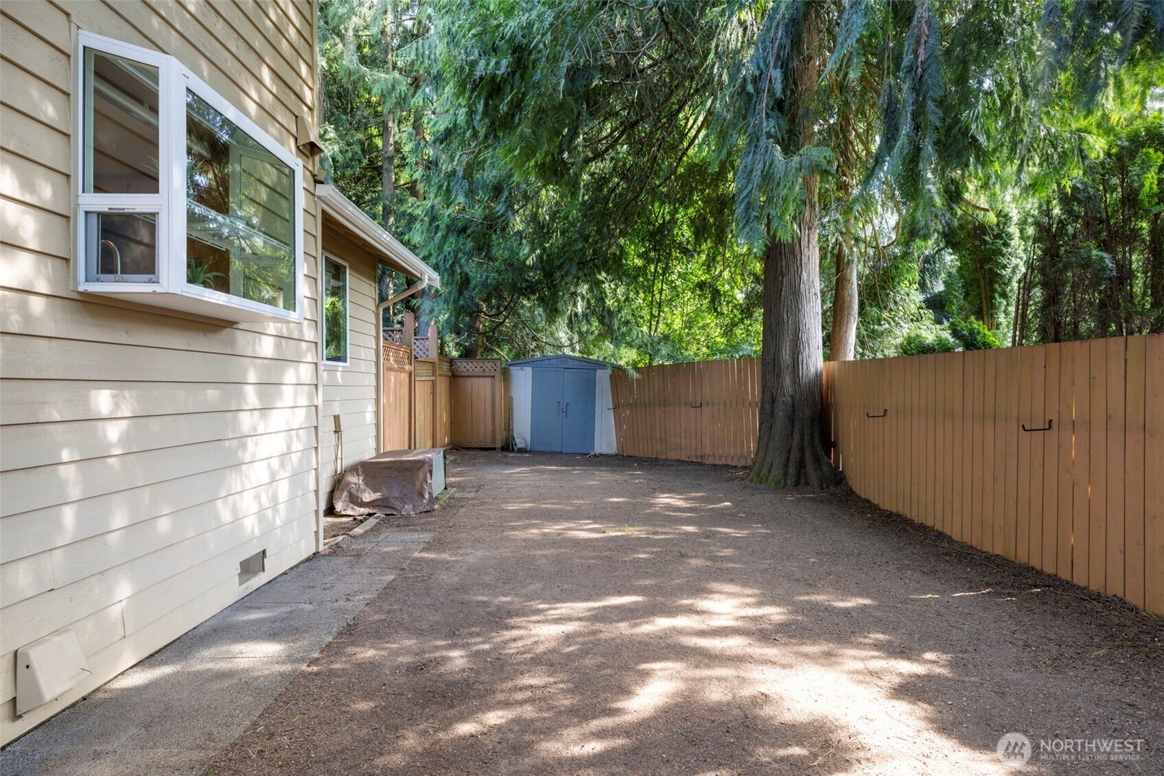 Private, fully fenced, and shaded backyard.