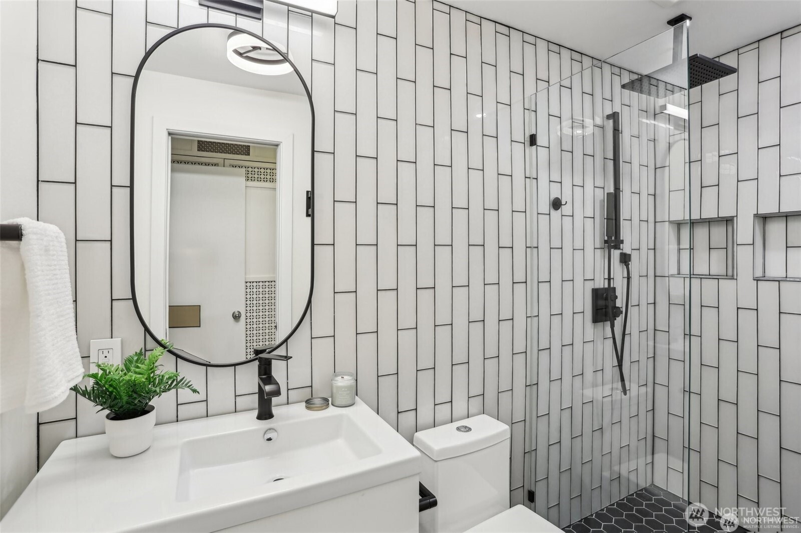 Remodeled bathroom with modern features such as a rainfall shower head.